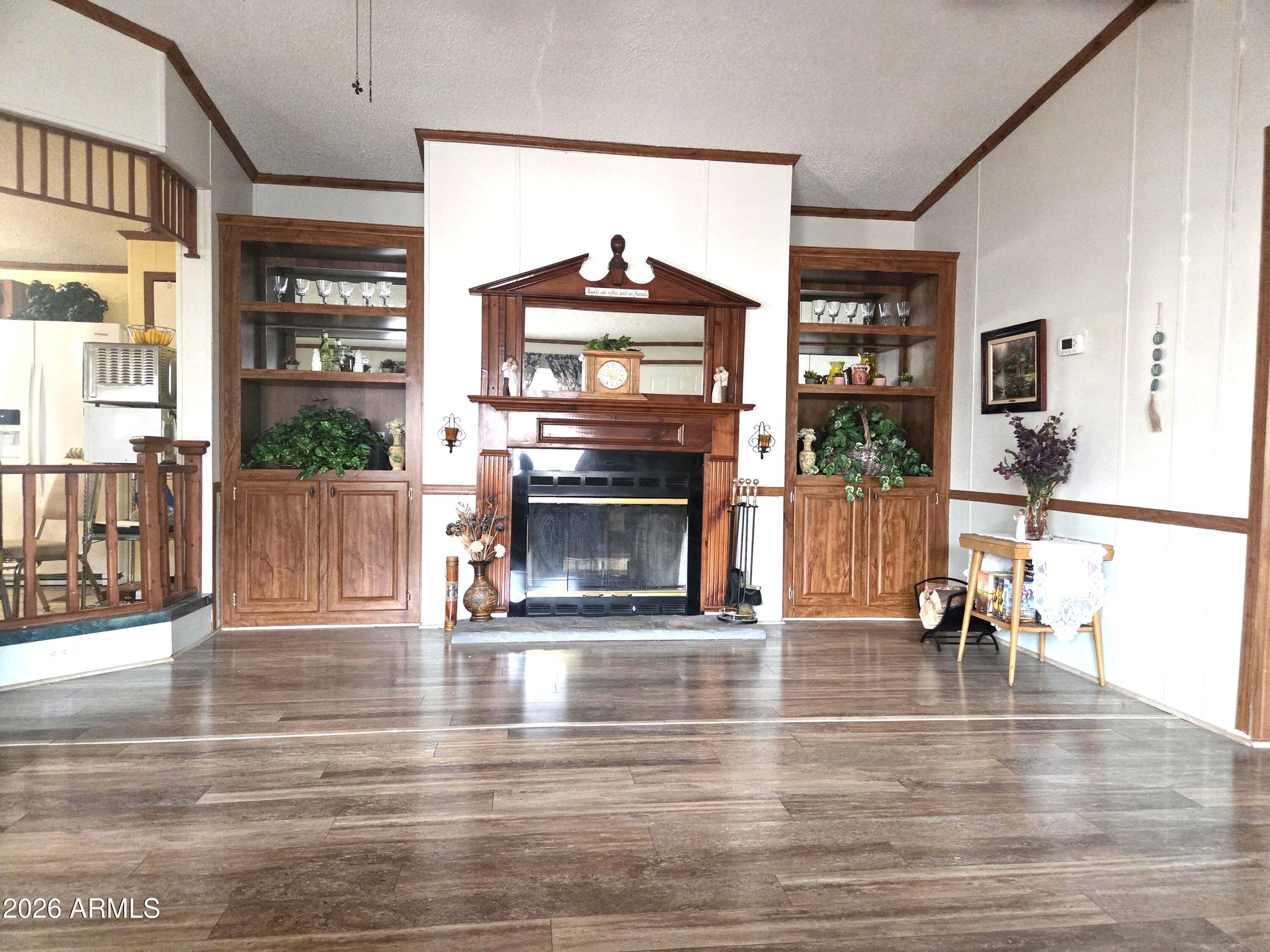 PRICE REDUCED!! - Beautifully maintained, FRESHLY UPDATED - Seller Motivated, 3 bedroom, 2 bath home with large rooms, walk-in closets and laminate flooring throughout. Walk-in handicapped shower in primary bath, Beautiful Wood Burning Fire Place in Living/Great Room area. LED Lights throughout home . Sit on this gorgeous Wrap Around Deck with ramp access and enjoy the AMAZING Mountain Views, Arizona Sunset, or bird-watching. Workshop/craft room off of back deck. Large shed, chain link fence in back, sits on leased land within a park. Park sports 2 Swimming Pools, one indoor & outdoor, heated, and a Hot Tub, Club house, overflow parking, Dog Park, Gym, Library and more. This is a great community to live in.