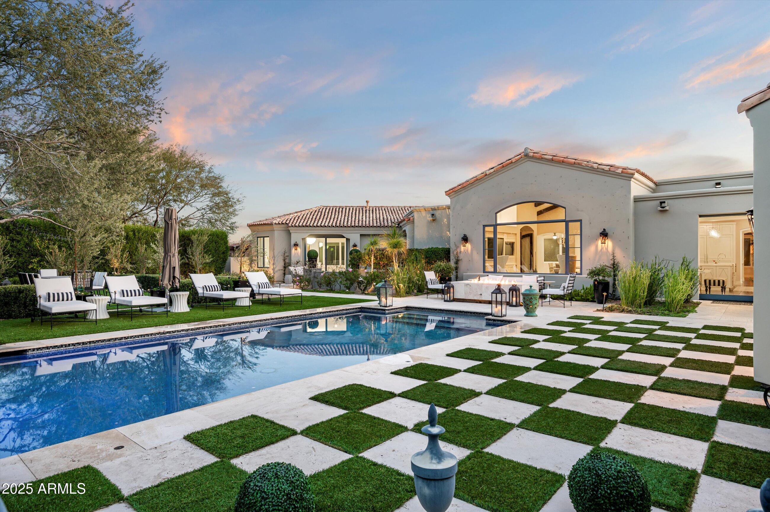 Graceful character and style, as if right out of a storybook, this custom one level estate is situated on a premium cul-de-sac homesite with an impressive approach and mountain backdrop in sought after Country Club at DC Ranch guard gated community. Renowned for its charming uniqueness, this masterpiece has been fully updated with meticulous focus on design detail and authentic finishes. With artistic diversity as a cornerstone, this extraordinary estate is one of a kind. Where resort meets fairytale, transport into a picturesque backyard with enchanting garden rooms defined with lush, manicured landscape and trees anchored with a striking pool with graceful deck streams.  Get lost in the charming landscape, as each garden room unfolds into another one.  Enjoy an outdoor eat in kitchen with pergola, separate stone deck dining area, turfed lounge area, prominent fire pit gathering area, turfed sunken conversation lounge, expanse with checkerboard stone and turf adds further appeal.  
Desirable home plan with detached guest house with living, bedroom and kitchenette, plus additional attached private entry casita, with sitting, flex/exercise room with two additional ensuite bedrooms split from primary suite.  Spacious flex room with double built-in desk with command center, lounge and gathering areas with fireplace and wet bar, media/den off the grand family room with large, picturesque window bringing interior and exterior harmony.  Marvel in the details from woodwork to wallpapers, first class finishes abound.  Eat in kitchen with built-in corner nook boasts oversized island with state-of-the-art appliances including La Cornue gas range, double ovens, plus steam and microwave built-ins, warming drawer, 2 dishwashers, ice maker, and built-in fridge and freezer.  Butler pantry with elegant temperature-controlled glass wine wall sits suitably between kitchen and dining.   Private spa access off spacious primary suite with sitting area, hand laid Michael Aram tiled fireplace wall, with spirited spa like bath with free standing soaker tub and steam shower, three vanities, built-in Miele coffee bar, and dual wardrobes closets. First class finishes throughout with rich hardwood flooring to eye catching light fixtures, details abound.  Captivating in every way, this is an exceptional property with distinct appreciation for elegance.