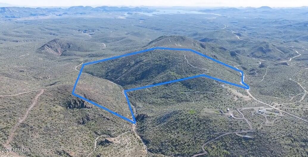 This is an amazing opportunity to own a large 133+-acre land parcel nestled against State land, located in an unincorporated area of Yavapai County, near Lake Pleasant, approximately 25 minutes from the TSMC plant and the Loop 303 highway. It offers off-grid living with private access to Cottonwood Creek (which runs through the property) and is suitable for building your dream home or a tiny house to get away on the weekends. Yavapai Co. offers a few free pre-approved house plans to simplify the permitting process and potentially reduce costs. Wells are 100- 400 feet deep. No mobile homes are allowed. 1 house per 2 acres. Coordinates are under the document tab.