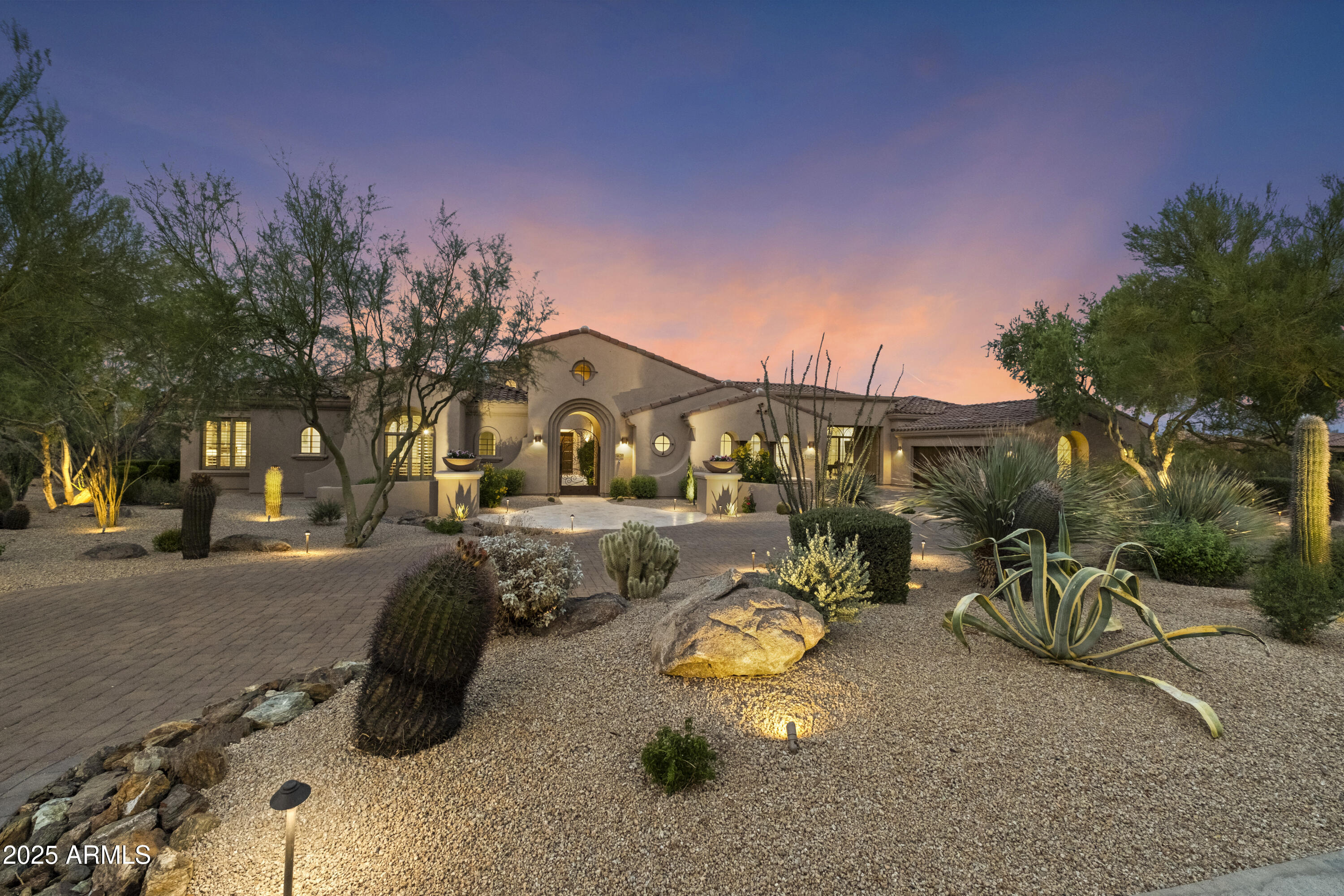 A rare expression of desert luxury, this newly reimagined estate in Saguaro Estates is a masterclass in design, scale, and refinement. Offered fully furnished, the residence unfolds across more than 7,400 square feet of curated interiors where timeless architecture meets elevated modern living. From the moment you pass through the private gated courtyard, soaring 21-foot ceilings with exposed wood beams and dramatic stone accents set a tone of understated grandeur.

Every detail has been thoughtfully composed--from rich Daltile flooring to over 30 slabs of hand-selected quartzite and marble--creating a home that feels both sophisticated and effortlessly livable. At its heart, the chef's kitchen is as functional as it is striking, anchored by Taj Mahal quartzite, dual islands, custom alder cabinetry, and a full Thermador appliance suite.

Designed for both intimate evenings and large-scale entertaining, the estate offers a private theater, billiards lounge, and elegant wet bar, while walls of glass open to a resort-caliber backyard. Here, expansive covered patios, fireplaces, a built-in BBQ, and a PebbleTec pool and spa create a setting reminiscent of a five-star retreat.

The primary suite is a sanctuary of its own--complete with a fireplace, spa-inspired bath, dual dressing rooms, and a private fitness space. Guests are welcomed with exceptional comfort in a detached casita and en-suite accommodations. An executive office, integrated lighting and sound, and a climate-controlled four-car garage with EV capability complete this extraordinary offering.

Perfectly positioned in the coveted 85266 zip code, this private estate offers the ideal balance of seclusion and convenience--just minutes from Loop 101, the future Arizona Cardinals headquarters, Mayo Clinic and Honor Health, with easy access to North Scottsdale's premier golf, dining, and shopping destinations, including Troon, DC Ranch, and Scottsdale Quarter.

This is more than a home--it is a statement of lifestyle, presence, and enduring design in one of North Scottsdale's most coveted enclaves.