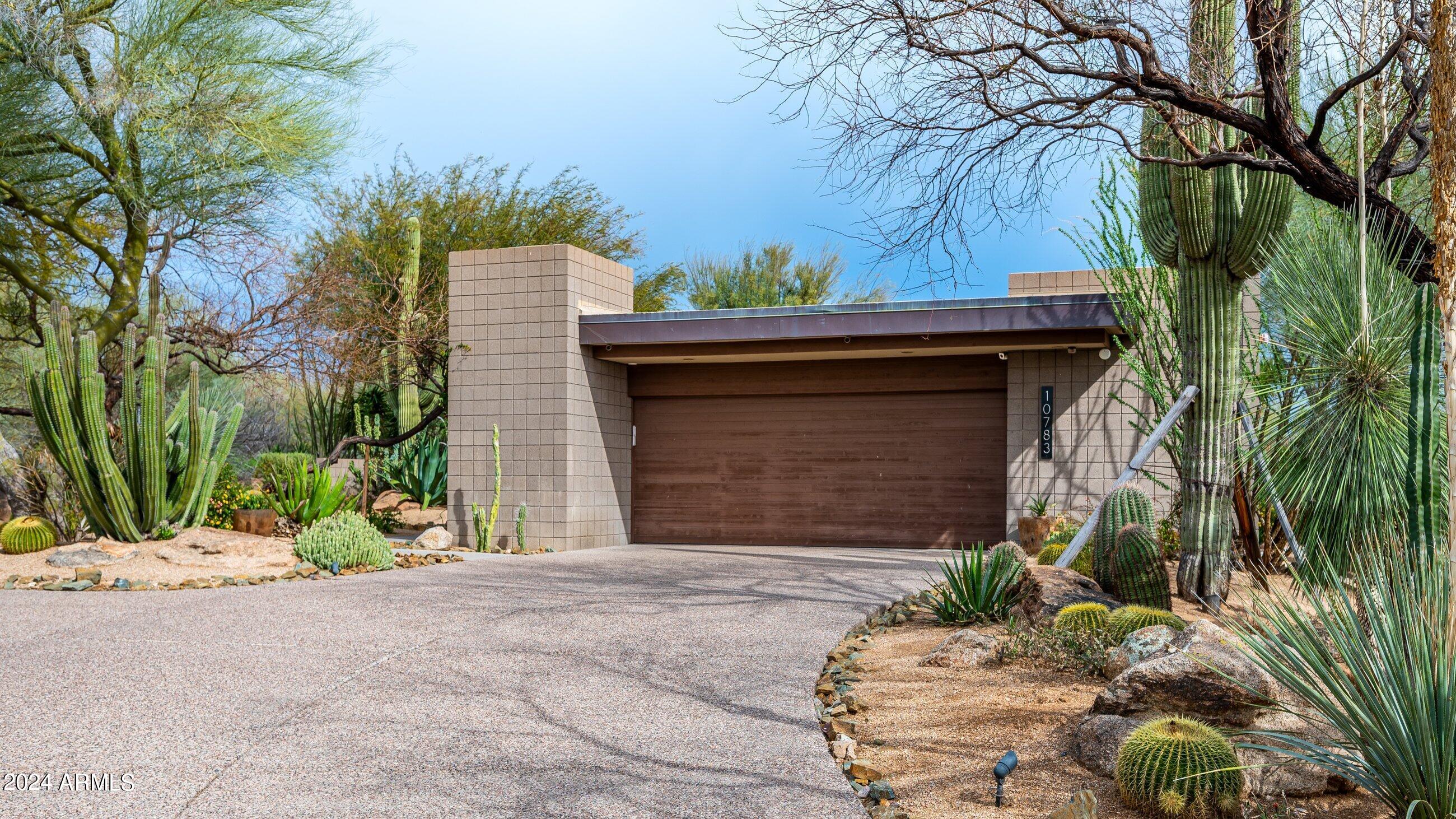 This sophisticated modern residence effortlessly integrates with the newly established desert organic motif. A beautifully matured landscaped courtyard offers captivating sunset vistas. Nestled on a coveted private end/corner lot, the property boasts panoramic views to the south and overlooks the fairway/green of Apache Golf Course's fourth hole. The remarkable yet secluded outdoor living area showcases a glistening pool and spa, a built-in BBQ, gas fire pit, and lush landscaping with various lounging spots to relish sunrises, sunsets, and the glimmering valley lights. Featuring 4 bedrooms and 4.5 bathrooms, this residence eliminates interior steps and boasts numerous upgraded finishes including honed granite countertops, bespoke cabinetry, two fireplaces, and wood/flagstone flooring. The expansive Kitchen highlights a wolf appliance package, making it ideal for hosting gatherings.
No membership to the Desert Mountain club is available with this property but available through the Club to purchase, waiting list will apply.