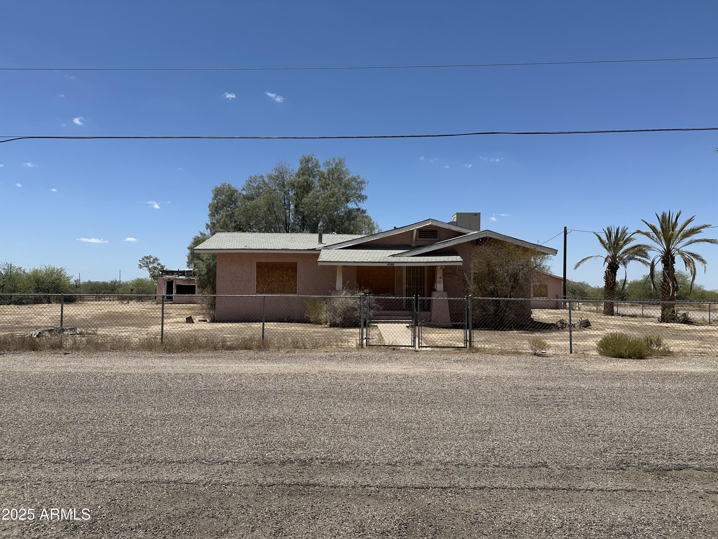 This Commercial property is zoned I1 through the City of Eloy. Multi use light industrial. Property is within 1/2 mile of I-10 and minutes from I-8. Existing structure on property. 3 Bedroom , 3 bath home. Home needs Repairs. As is.  Beautiful Wood finish in bedroom and living room. Lots of shelving in kitchen area. Utilities are not on.  Huge 3-4 Car garage. It Needs repairs. Some shelving inside. Security doors on home and one door to garages. Partial fencing around property. Make this your home with lots of room to park all your trailers, rangers, boats etc. You can also make it a business venture and live on the property. Check with City of Eloy on Habitability, permits etc. Great location behind the Villa Oasis School. Home has seperate parcel. 12 Lots included in sale. Sold together