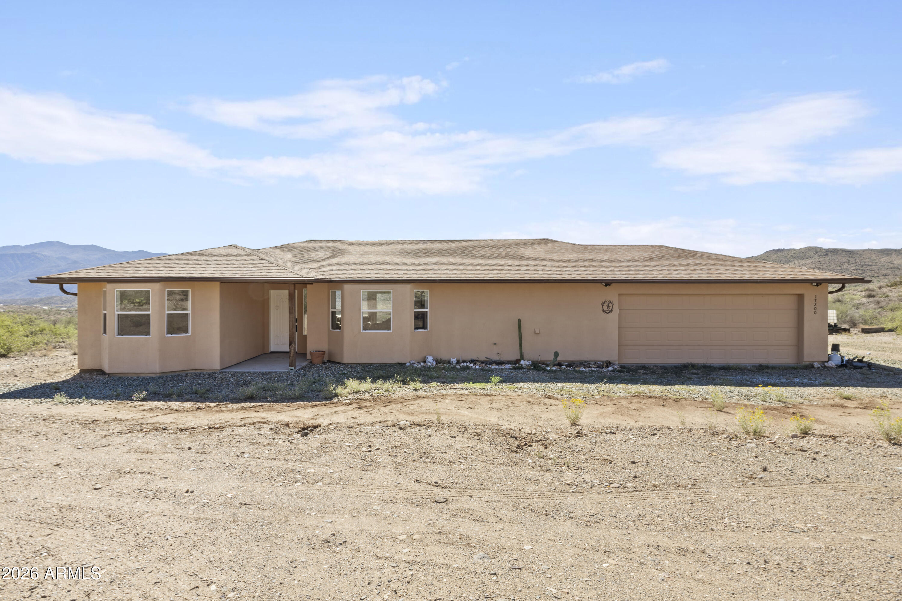Discover this custom-built gem in the scenic Bradshaw Ranches of Mayer, AZ. Set on 7.15 acres with breathtaking mountain views, this 3-bedroom, 2-bath split floor plan offers the perfect blend of comfort and craftsmanship. Located just minutes from Cleator and Crown King, it's an ideal home base for adventure seekers and nature lovers alike. Quality is evident in every detail of this fully permitted home. From the energy-efficient spray foam insulation and rustic mesquite window sills to the luxurious primary suite featuring a copper clawfoot tub and custom vanity, no expense was spared. The oversized garage provides massive space for a workshop, vehicles, or all your outdoor toys. Whether you're looking for a peaceful full-time residence or a versatile mountain getaway, this unique property offers the freedom and flexibility to make it your own. Experience high-country living with modern luxury--schedule your tour today and see the stunning Arizona landscape for yourself.