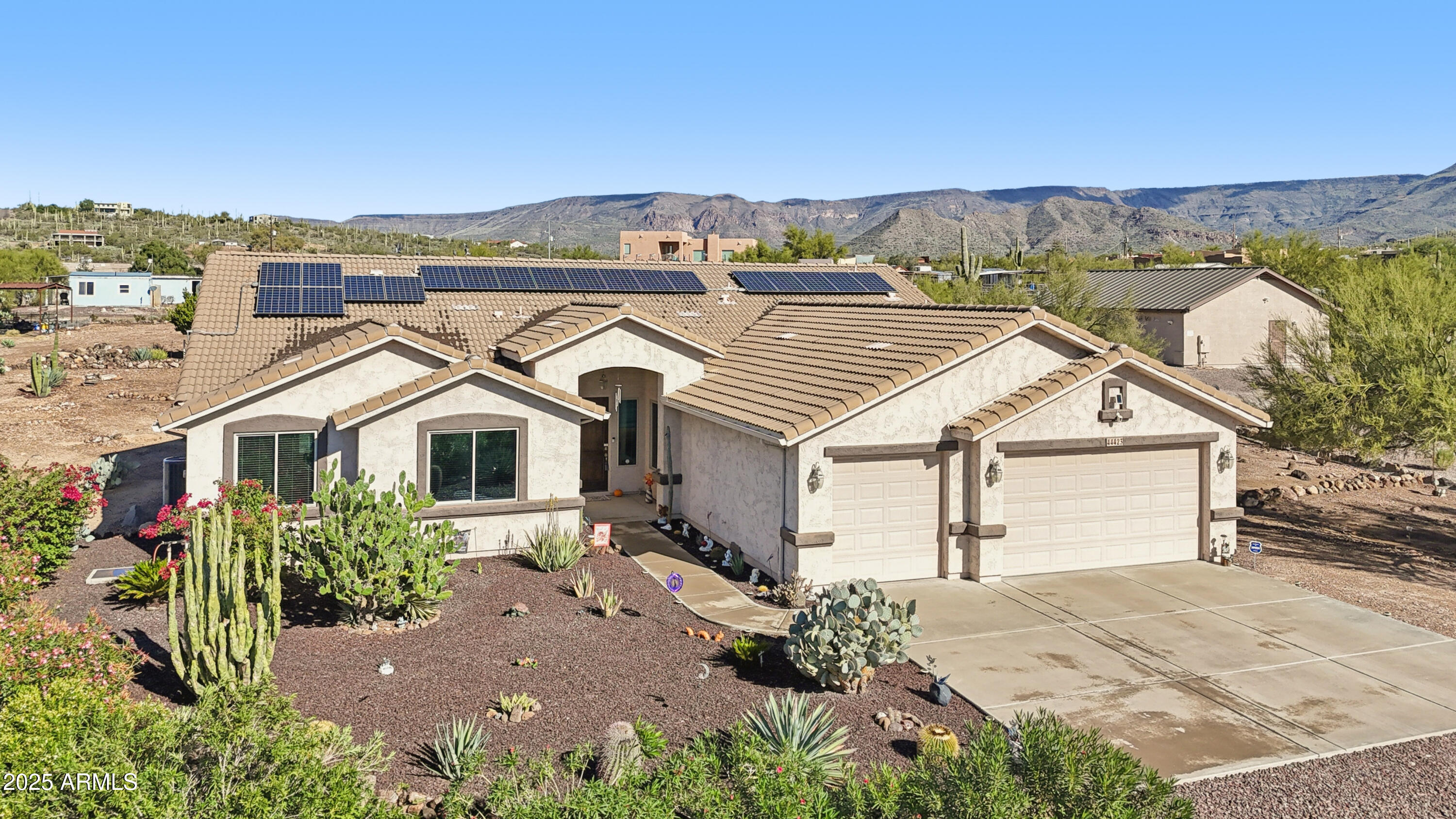 Welcome to peaceful desert living on 1.143 acres in the highly desirable Circle Mountain area of New River. This single-level home offers panoramic mountain views, a functional split layout, and the freedom of wide-open land with room to expand, store, or build. Set back from the road with a long private drive, the property features owned solar (average electric bill is under $20 per month), new windows (2015), new hot water heater (2022), and a brand-new Trane HVAC system installed in April 2025 for total efficiency and comfort.

Inside, the home features a bright and open living space anchored by large picture windows and a cozy fireplace, all flowing directly into the spacious kitchen with an oversized island, abundant cabinetry, and wide views of the property. A second living area off the kitchen makes the layout ideal for multi-use living, whether you need a family room, game room, or large formal space.

The split floor plan offers privacy, with the primary suite set on its own wing and featuring a full ensuite bath, dual vanities, a soaking tub, a walk-in shower, and multiple closets. 

The opposite wing includes three additional bedrooms and a full bathroom, giving plenty of space for family, guests, a home office, or hobbies. A dedicated laundry room, powder bath, and large 3-car garage complete the interior.

Outdoors, the possibilities are endless. The property includes mature desert landscaping, citrus trees, natural rock features, and wide-open usable space for trailers, RVs, animals, a workshop, or a future pool. 

Enjoy gorgeous sunrise and sunset views, quiet surroundings, and the open-space lifestyle that makes New River so special, all while remaining close to Anthem amenities, I-17 access, dining, and shopping.

This is the acreage property buyers wait for, updated systems, owned solar, a functional floor plan, and beautiful natural surroundings. Move-in ready and easy to personalize for your ideal desert retreat!