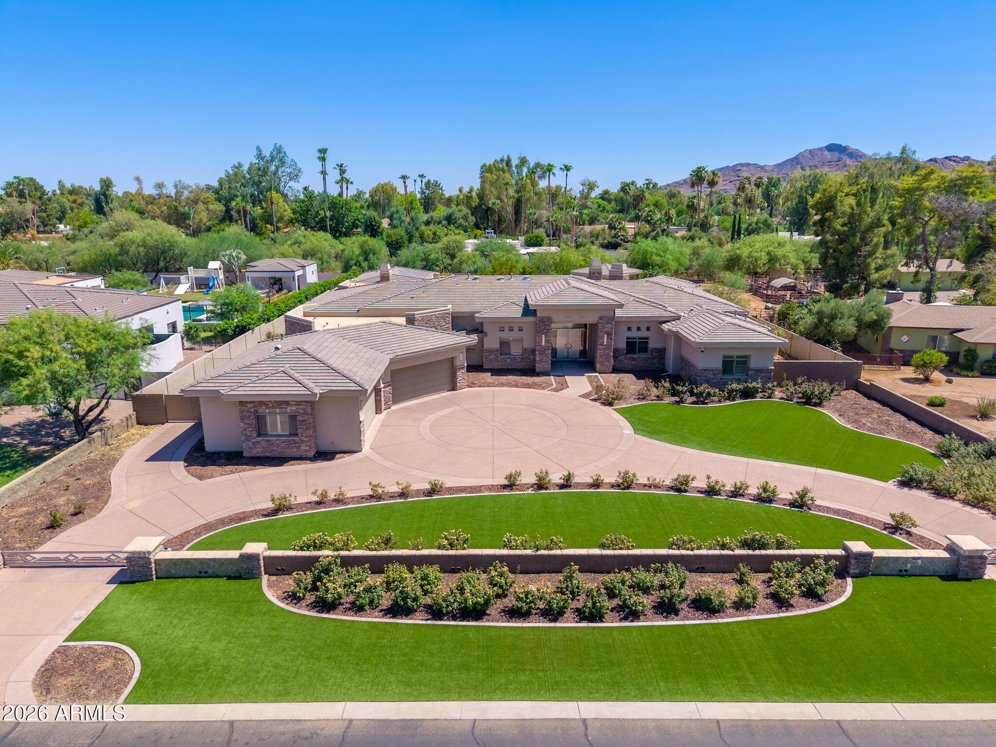 Nestled within the highly sought-after Rancho Sunnyvale community, this custom estate showcases timeless architecture, exceptional scale, and a thoughtfully designed split floor plan that balances everyday living with effortless entertaining.

From the moment you enter, soaring coffered ceilings, expansive windows, and abundant natural light create an impressive sense of openness. The primary suite occupies its own private wing, offering a peaceful retreat complete with dual walk-in closets featuring washer and dryer hookups, a spacious primary bath, and an adjoining bonus room ideal for a fitness studio, private lounge, or wellness space. A dedicated office or den sits just across the hall, providing an ideal work-from-home environment. At the heart of the home, the open-concept great room seamlessly connects the living, dining, and kitchen spaces. A generous center island, wraparound breakfast bar, custom wet bar, gas fireplace, and pocket sliding glass doors create an inviting setting for gatherings while blending indoor and outdoor living.
Privately situated off the main living area, the guest suite offers direct access to the backyard, making it an excellent option for multigenerational living or extended guests.
Set on an expansive lot, the outdoor living space features a gated driveway, four-car garage, RV gate, extended covered patio, and a resort-style backyard designed for year-round enjoyment. Every bedroom includes an en-suite bathroom and walk-in closet, providing comfort and privacy throughout this exceptional home.