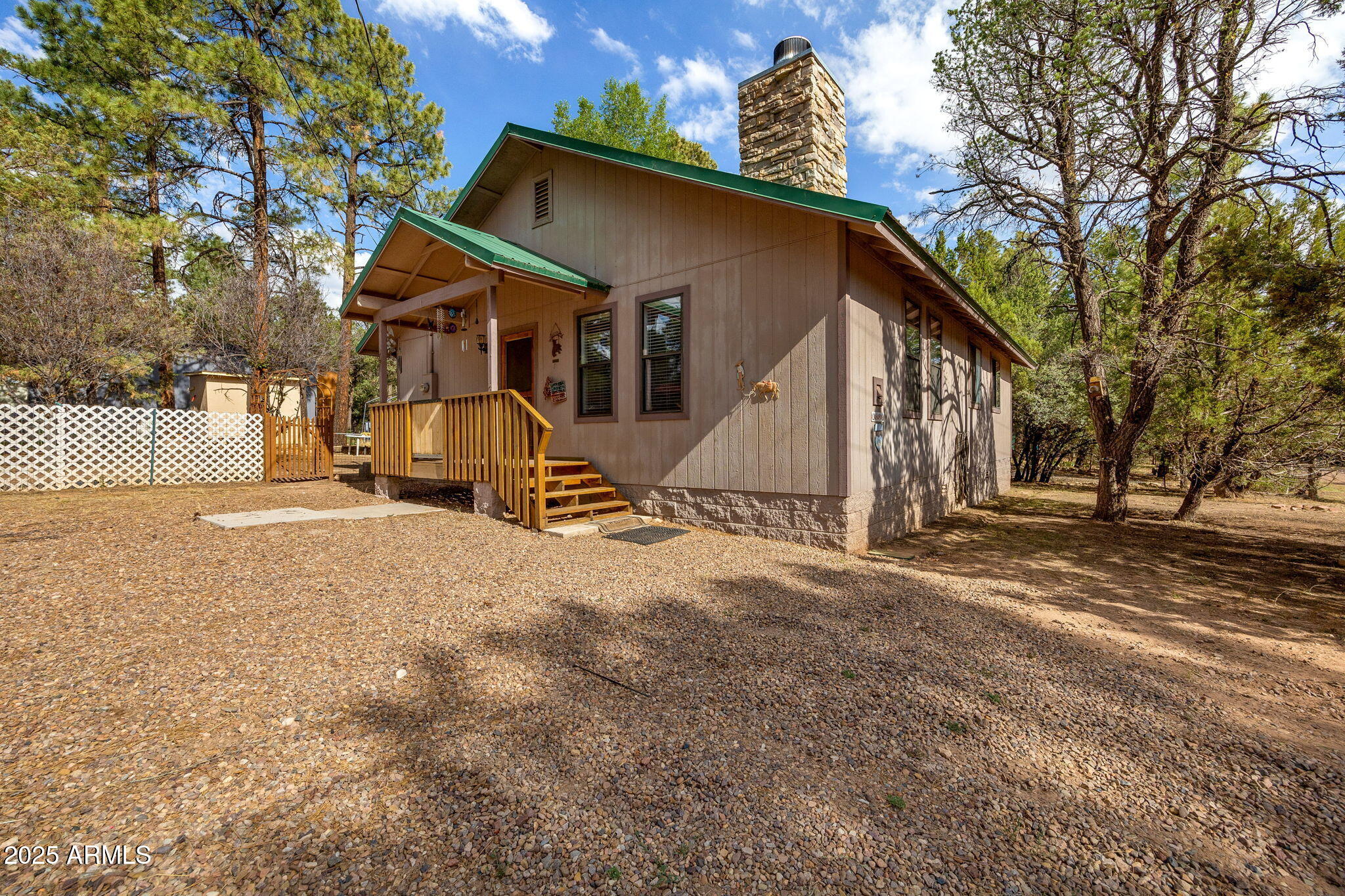 Escape the heat at this charming Mountain Retreat, nestled among tall pines! This 2-bedroom, 2-bathroom home is situated on a peaceful .18 acre lot with a beautifully treed yard. Cozy up by the wood-burning fireplace in the living area, making winter nights truly special. Located just off a paved street, this home offers privacy and convenience, with a partially fenced yard perfect for pets or outdoor activities. With no HOA and a short distance from a paved road, this centrally located gem is near local services. Don't wait this property won't last long!