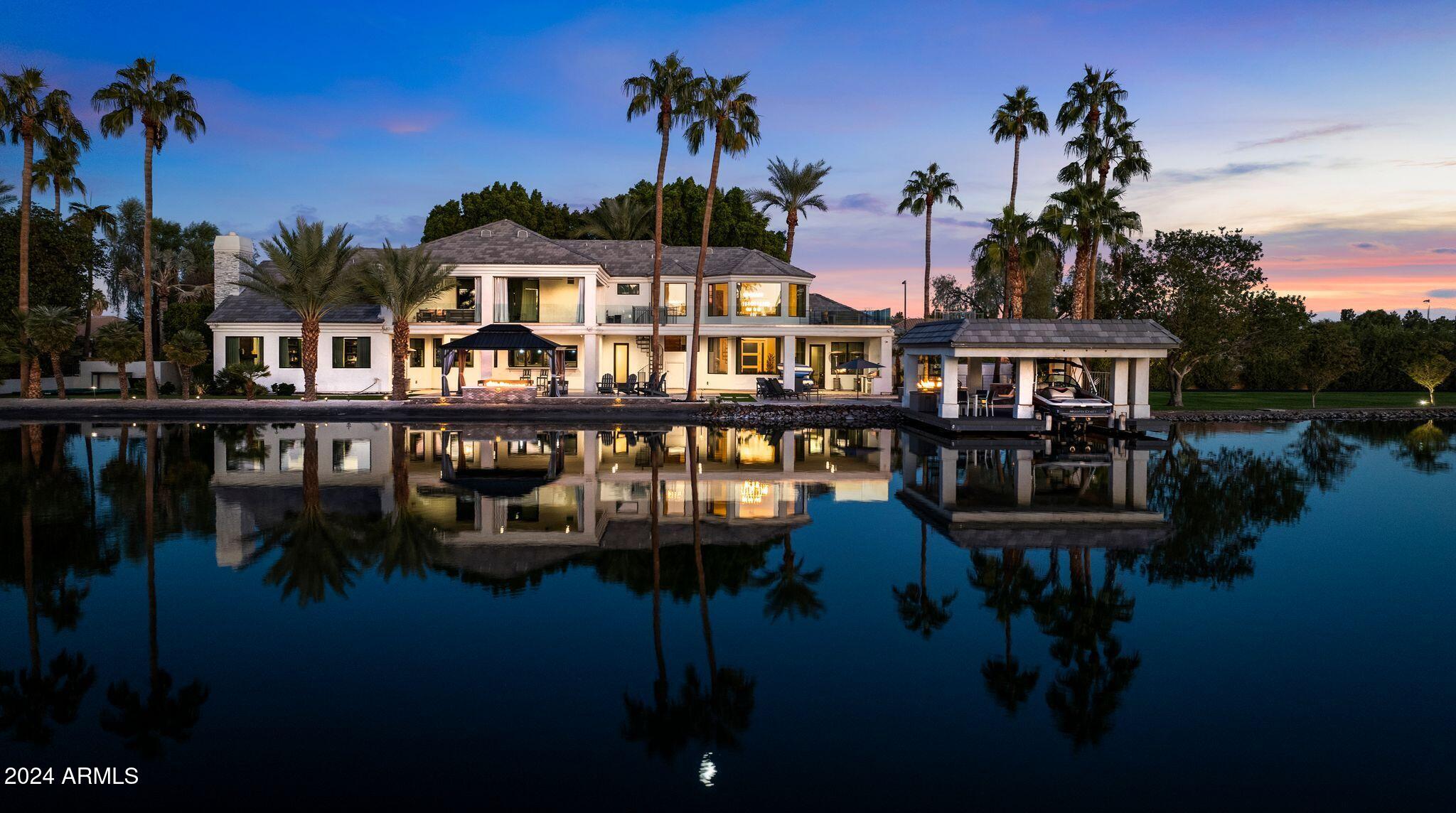 Introducing an extraordinary estate located in the most established and coveted regulation ski lake in Arizona. Upon entry to the exclusive gated community of Crystal Point Estates, you will find a ½ mile lake spanning with islands on each end. As you make your way to your waterfront home, you are welcomed by a soaring entry with captivating lake views and rich finishes. Gourmet kitchen delivers two ovens, icemaker, RO, granite & quartz counters, and a wet bar which opens to seamlessly blend indoor-outdoor living. Primary Suite features rooftop hot tub, private patio, spa-like bathroom w/ standalone tub, flawless tiled shower, kitchenette/laundry room combo, coffee bar, designated safe room and sophisticated firearm storage, and an elegant closet. Home boasts premiere amenities such as transparent wine/liquor display, theater room, 2 laundry rooms, smart toilets, and EV charging station. Enjoy the vibrant scenery outdoors by your heated pool & spa, covered boat dock with rooftop deck, or distinguished firepit nestled along the sandy shoreline. This home impeccably combines luxury living, high end entertaining opportunities, and waterfront attractions. Truly a one-of-a-kind, where design and location cannot be replicated. Be sure to watch the remarkable video!