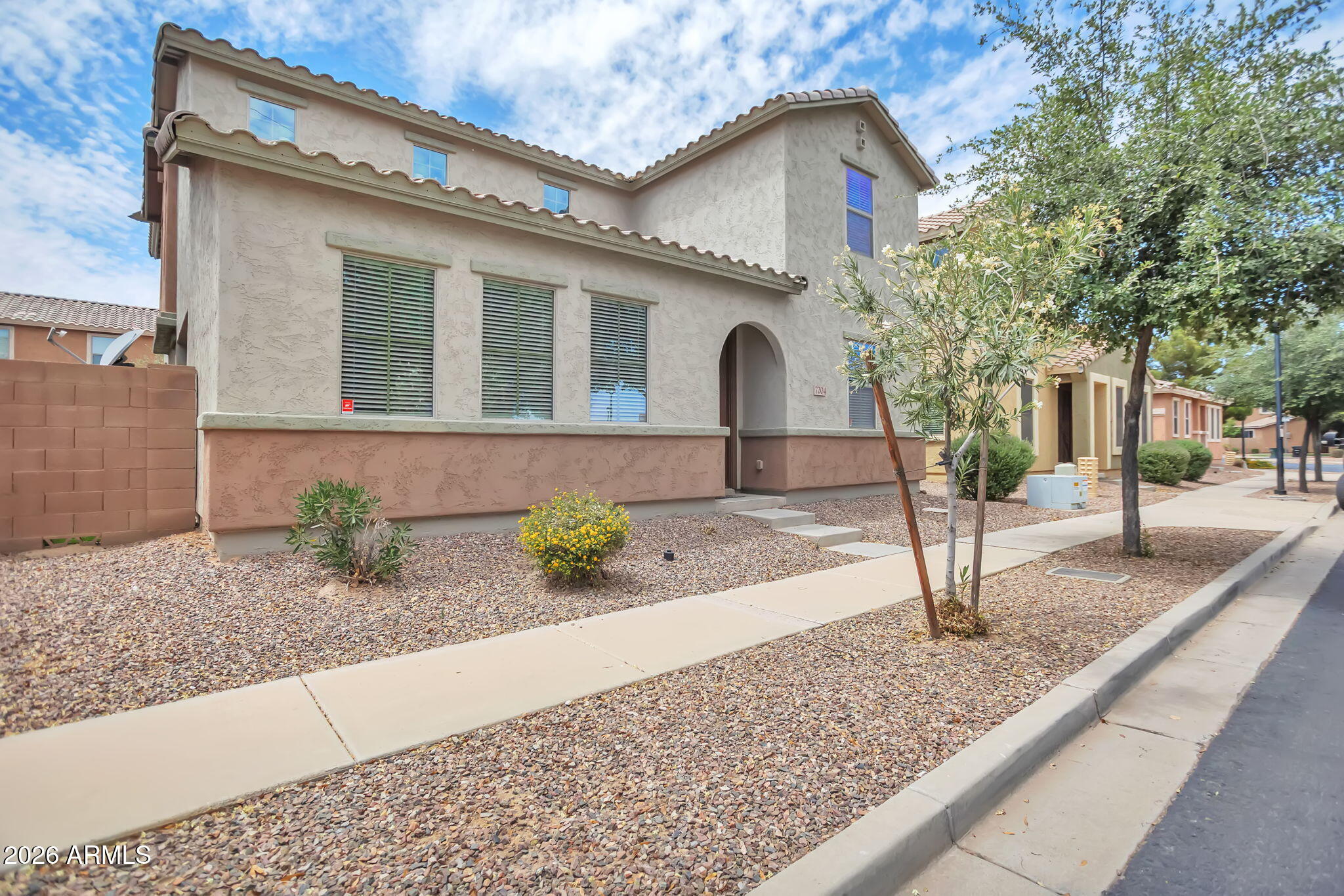 Welcome to this well-maintained home in a desirable Phoenix location. The flexible floorplan offers a spacious living room and family room, plus a full bedroom and bath on the main level--ideal for guests or multi-generational living. Upstairs features a generous loft, a comfortable primary suite with en-suite bath and ample closet space, along with two additional bedrooms. The backyard is designed for easy living with artificial turf and a covered patio--perfect for relaxing or entertaining. Conveniently located near schools, parks, shopping, and quick access to the I-10 and Loop 202.
