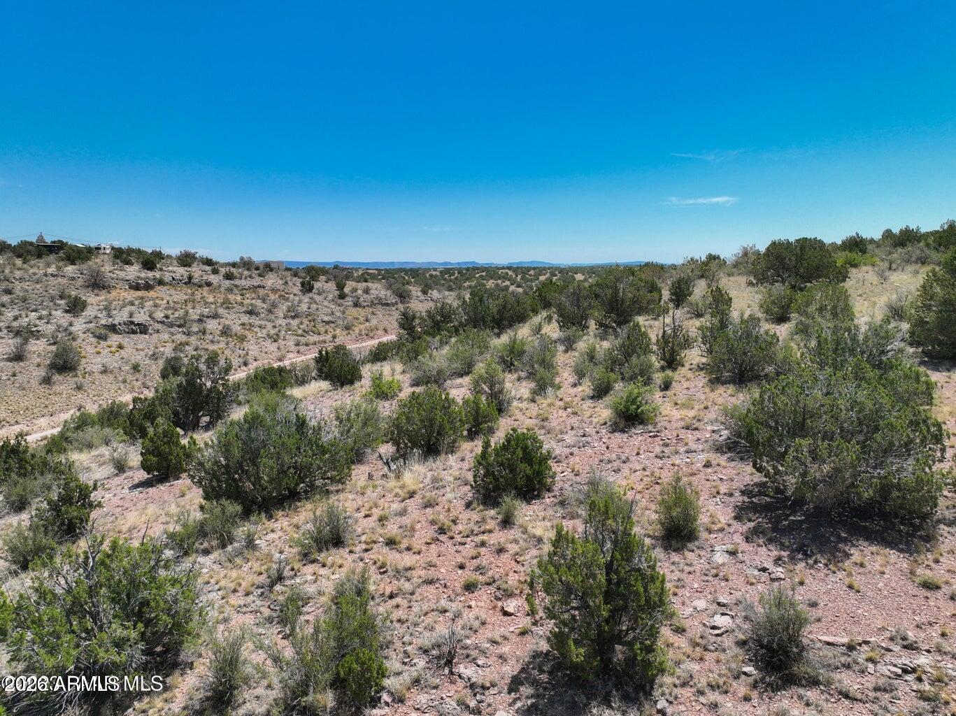 Premium panoramic view lot in a premier estate-home subdivision in Yavapai County. Nearly 8 acres (7.94) zoned RCU-2A, maintains long term value with low density and privacy, offering the ideal setting to build a custom dream home with room for a guest casita and horses. Enjoy privacy, tranquility, and wide-open space surrounded by natural beauty and sweeping views. Minimum build 1,750 sq ft. Low annual HOA of $61.87. A rare opportunity to create a private retreat or equestrian lifestyle property in a refined setting. Centrally located in Paulden near amenities, hiking, and outdoor recreation.