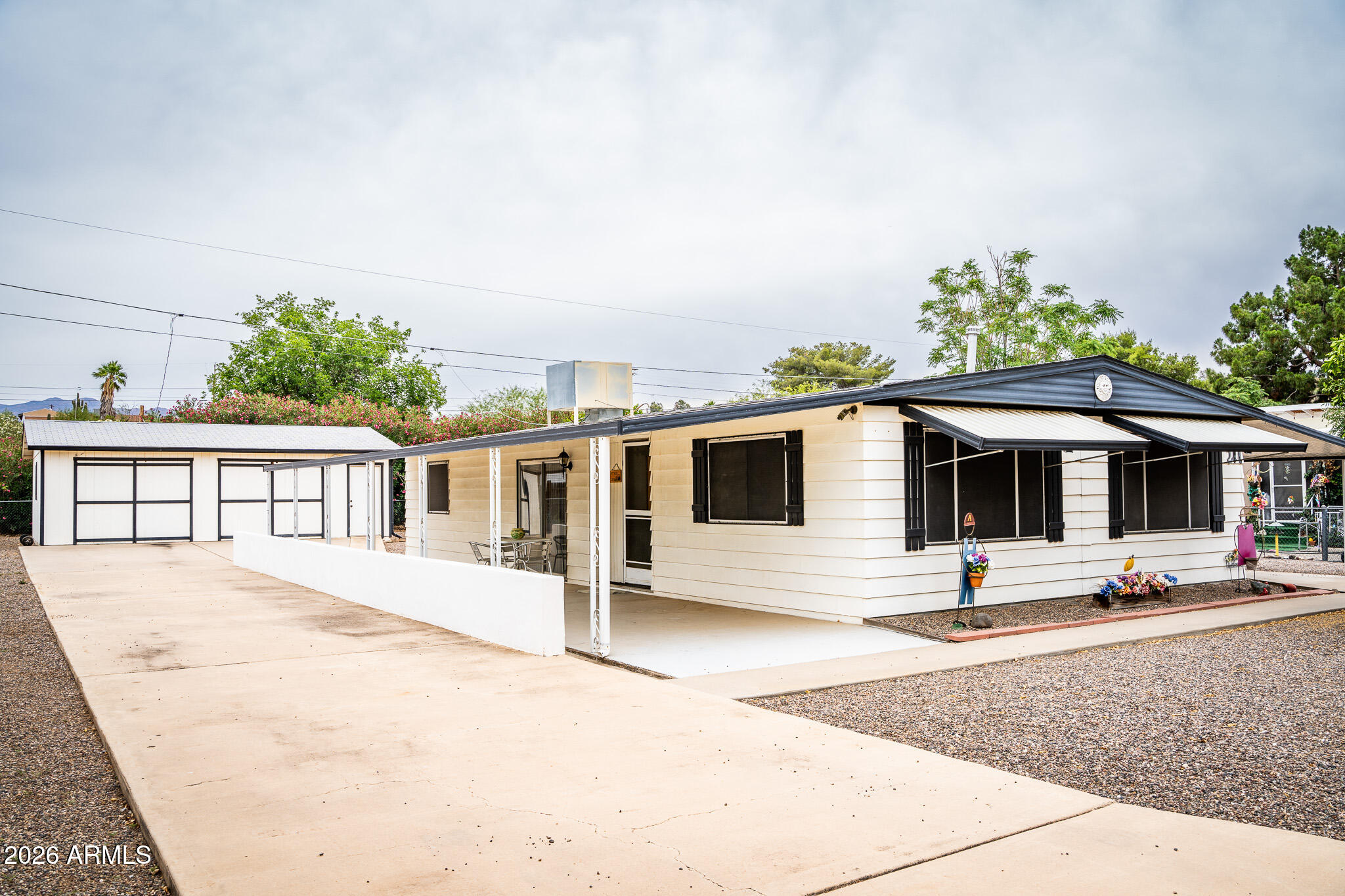 Immaculate 2-bedroom, 2 bath, manufactured home. This lovingly cared for home features 2 spacious bedrooms, and 2 full bathrooms. Enjoy a bright living room and a formal dining room perfect for gatherings. The home boasts a full-length covered patio and a full-length covered carport, along with a 2+ car garage. Situated on a well-manicured, fully fenced lot in a quiet neighborhood, this property offers both comfort and privacy.