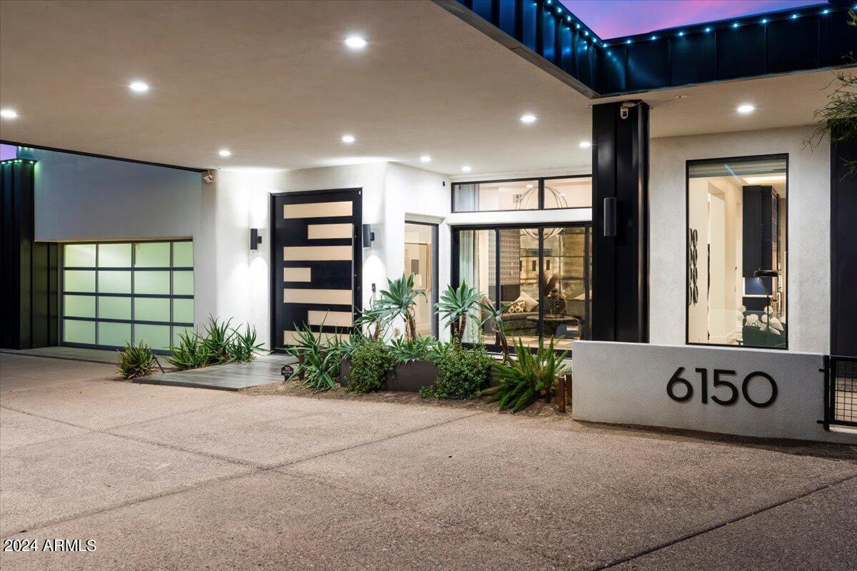 Introducing the reimagined Ralph Haver Adobe at 6150 N 20th St, a testament to refined living, meticulously elevated by the esteemed reThink Interiors. This magnificent 5,000 square foot jewel exudes an ambiance that effortlessly expands to a grand 7,500 square feet, making it the ultimate venue for sophisticated gatherings and cosmopolitan soirées.

Immerse yourself in unparalleled luxury with a host of exquisite upgrades, including dual quartz kitchen countertops, state-of-the-art appliances, and bespoke cabinetry designed for effortless entertaining. The floor-to-ceiling fireplace adds a touch of opulence, while retractable glass doors seamlessly merge indoor and outdoor living, extending to a covered patio equipped for alfresco dining. Delight in the meticulously landscaped grounds featuring a built-in barbecue, pickleball court, fire pit, and an in-ground trampoline. The pebble-finish pool, complete with a chic Baja shelf, invites leisurely afternoons, while the turf-covered expanse provides a picturesque setting for family-friendly events. Additional amenities include a diving pool, sport court, and playground, ensuring endless entertainment for all ages.

This estate is not merely a residence but a statement of grandeur and sophistication, crafted for those who appreciate the finer things in life.
