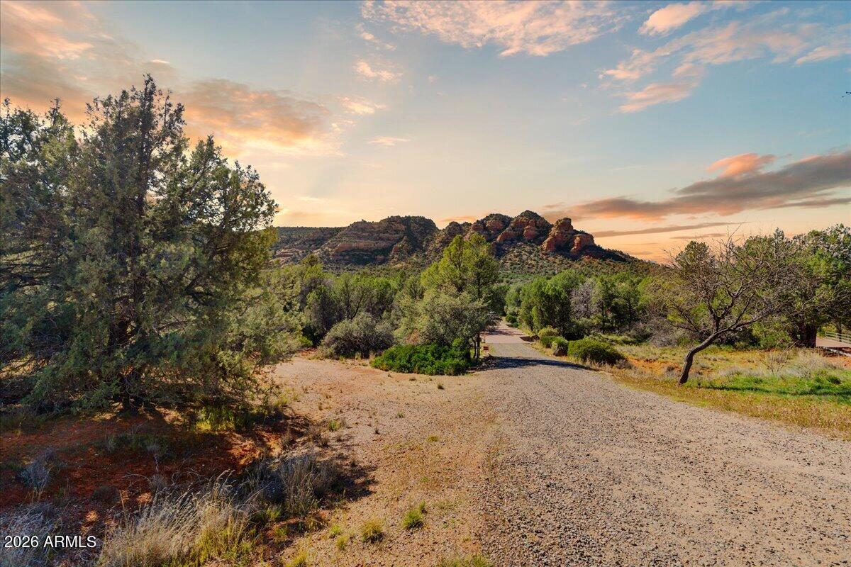 An Extraordinary Sedona Homesite
Opportunities like this are rare in the heart of Sedona. Situated off Valley Verde School Road, this 1.976-acre private estate parcel offers a remarkable setting surrounded by the natural beauty that has made Sedona world-renowned.
With unobstructed, panoramic red rock views of Cathedral Rock and the Seven Warriors, this property captures some of the most iconic scenery in all of Sedona. The expansive acreage provides exceptional privacy while still allowing convenient access to the area's renowned dining, recreation, and cultural experiences . Imagine designing and building a custom luxury residence perfectly positioned to embrace the sweeping red rock vistas, glowing sunsets, and the peaceful presence of Sedona's abundant wildlife. Rare Opportunity.