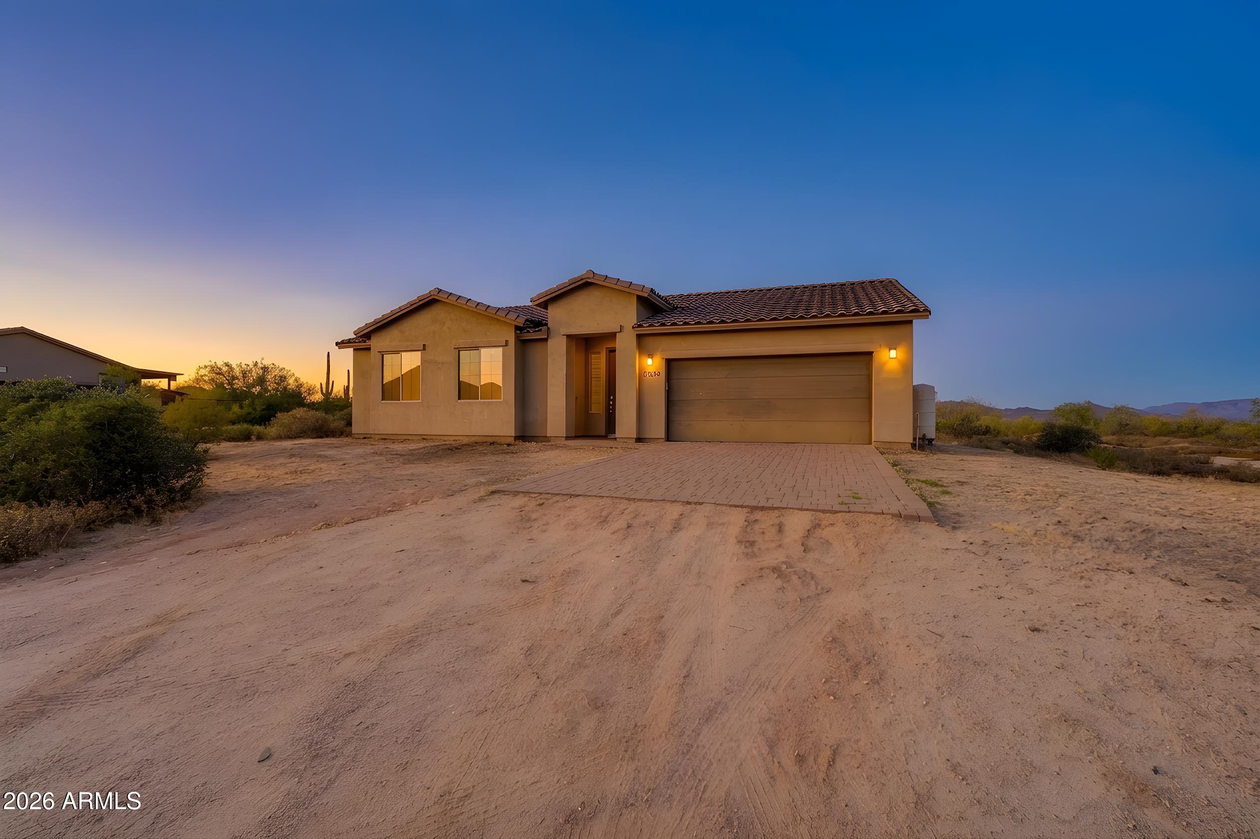 Located in the desirable Rio Verde area, this home sits on a spacious 1.28-acre lot with no HOA and stunning desert and mountain views. Offering 3 bedrooms, 2 bathrooms, and 1,639 sq ft, this single-level home features tall ceilings, an open floor plan, and upgraded finishes throughout. The kitchen includes granite countertops, stainless steel appliances, a walk-in pantry, and an eat-in dining area. Enjoy all-tile flooring, abundant natural light, and a covered patio with pavers perfect for relaxing and entertaining. Plenty of room for RVs, toys, animals, or future improvements.