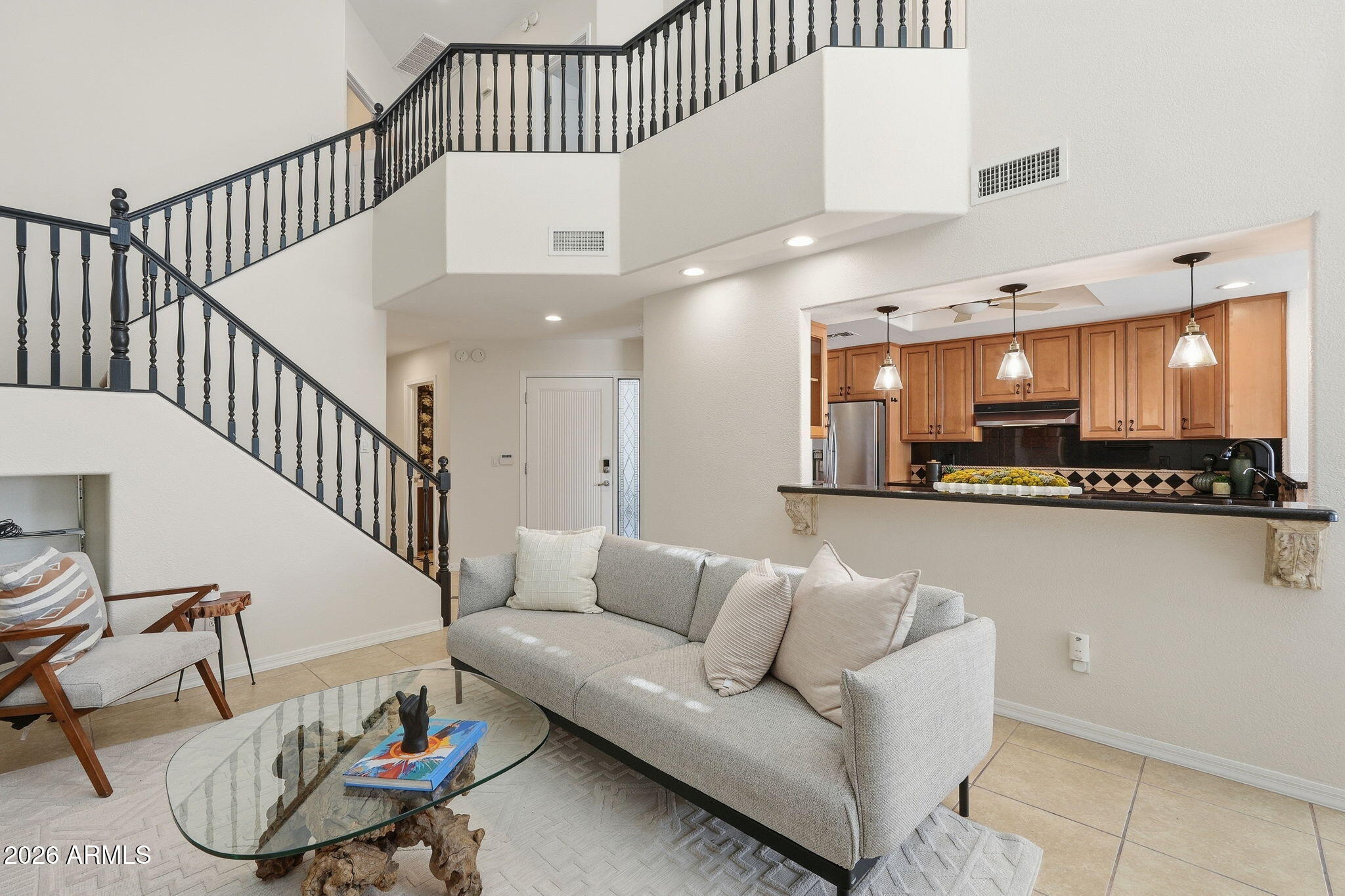 Located in the Heights at Glenrosa community, this quaint condominium combines luxury living with  an ultimate central location that keeps you close to some of the best dining, shopping, and entertainment in the Biltmore area. Inside, the large kitchen overlooks the living room perfect for entertaining. Granite countertops, beautiful cabinetry, a gas cooktop, breakfast bar, and bay window seating give the kitchen plenty of character and usable space. Plantation shutters throughout the home add a clean and timeless look, while the fireplace in the living room brings warmth to the main gathering area. Upstairs, the primary bedroom balcony offers city and mountain views that are especially enjoyable in the mornings or evenings when the weather cools down. Outside, the backyard features pavers and an outdoor fireplace, creating a cozy private outdoor space with easy maintenance.  Residents of Heights at Glenrosa also enjoy access to a community pool, spa, and cabana, adding even more ways to enjoy the Arizona lifestyle year round. Whether you're looking for your next investment or first time buy, this home checks all the boxes!