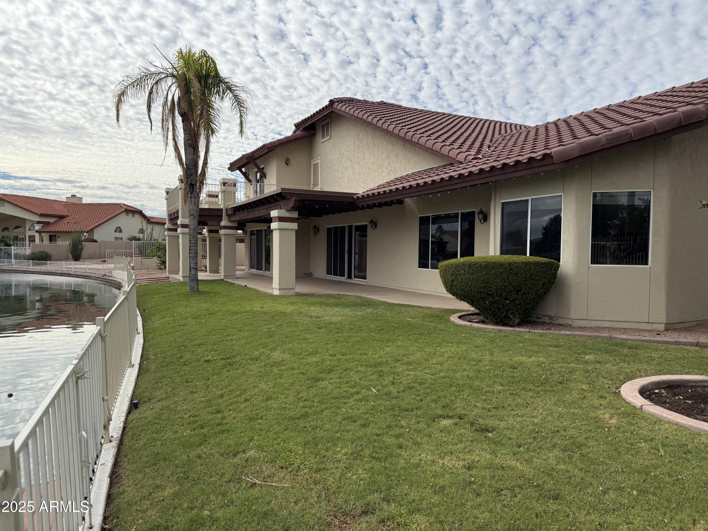 NEW A/C units May 2026. Enjoy waterfront living in a lovely neighborhood in Casa Grande.  This beautiful home has a lot of open space and several patios with the view of the lake.  Kitchen features granite countertops, double oven, and a huge recently remodeled walk-in pantry.  The living room has a fireplace and a great view of the lake. The master suite has 2 huge closets and an attached office/sitting room.  All bedrooms are large & on the main floor.  Upstairs is a sizeable bonus room or mother-in-suite with wet bar, bathroom, and balcony overlooking the lake.  The enormous amount of storage; both garages have shelving, and there is a functional workshop.
