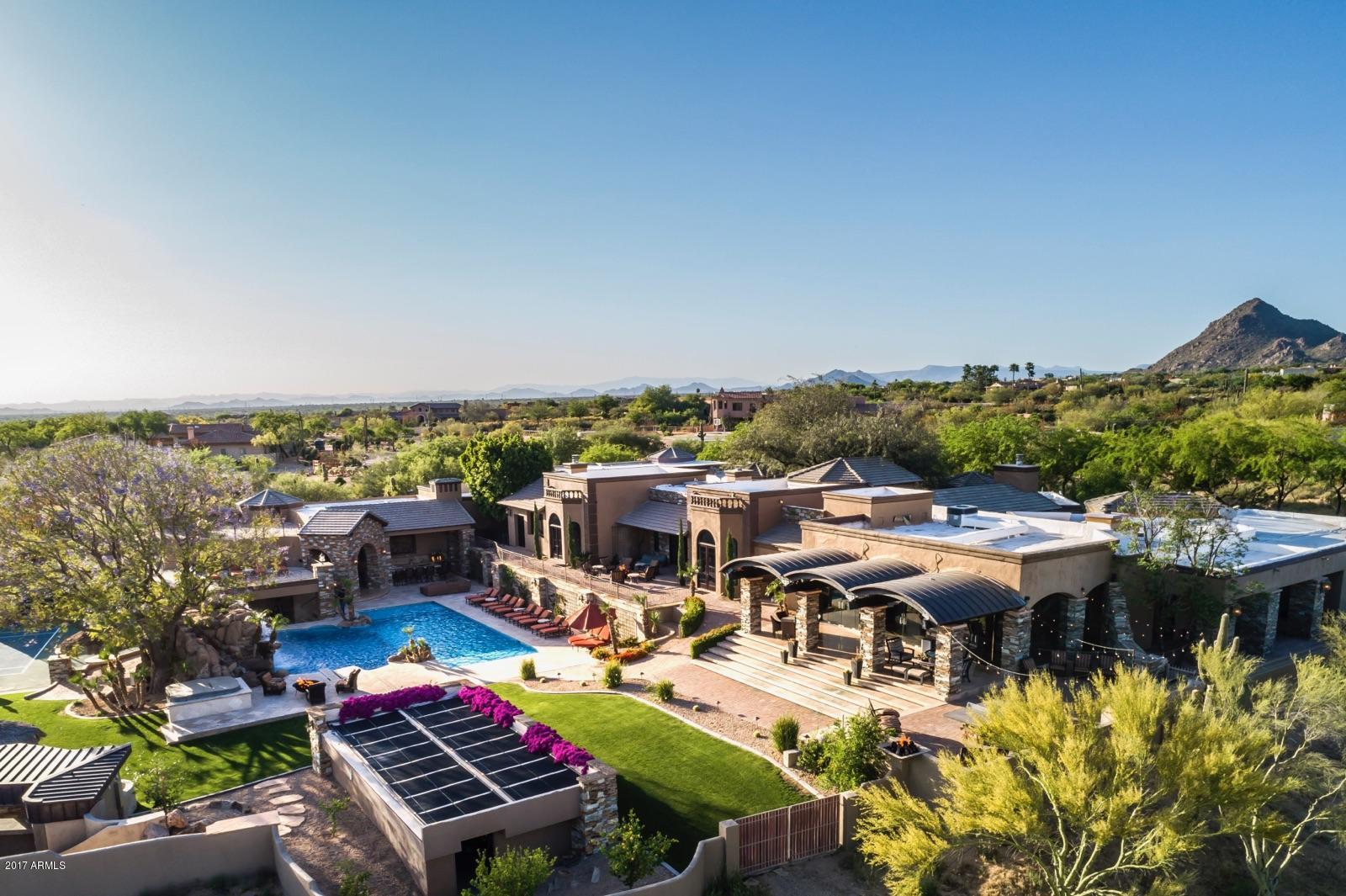 Private 8 plus acre North Scottsdale Estate! Extremely discreet to include every imaginable custom detail desired. Exquisitely appointed with light fixtures, vanities, mirrors, wine room, game room, library with floor-to-ceiling bookcases, custom office, an unbelievable 40-seat theater room w/stage area, sound board room, soda station and wet bar viewing area! Pro Athletes paradise, enjoy its complete Gym facilities, Sport Court, Putting Green, Olympic Pool, weight room, lockers, steam shower. Relax indoors or out, watch a game or your own indoor or outdoor Oversized Cinema Screen, multiple Sit-down bars and lounge space. Impeccably manicured grounds with waterfalls, a pond, oversized pool, fire pits and tennis court. Car aficionado's dream.