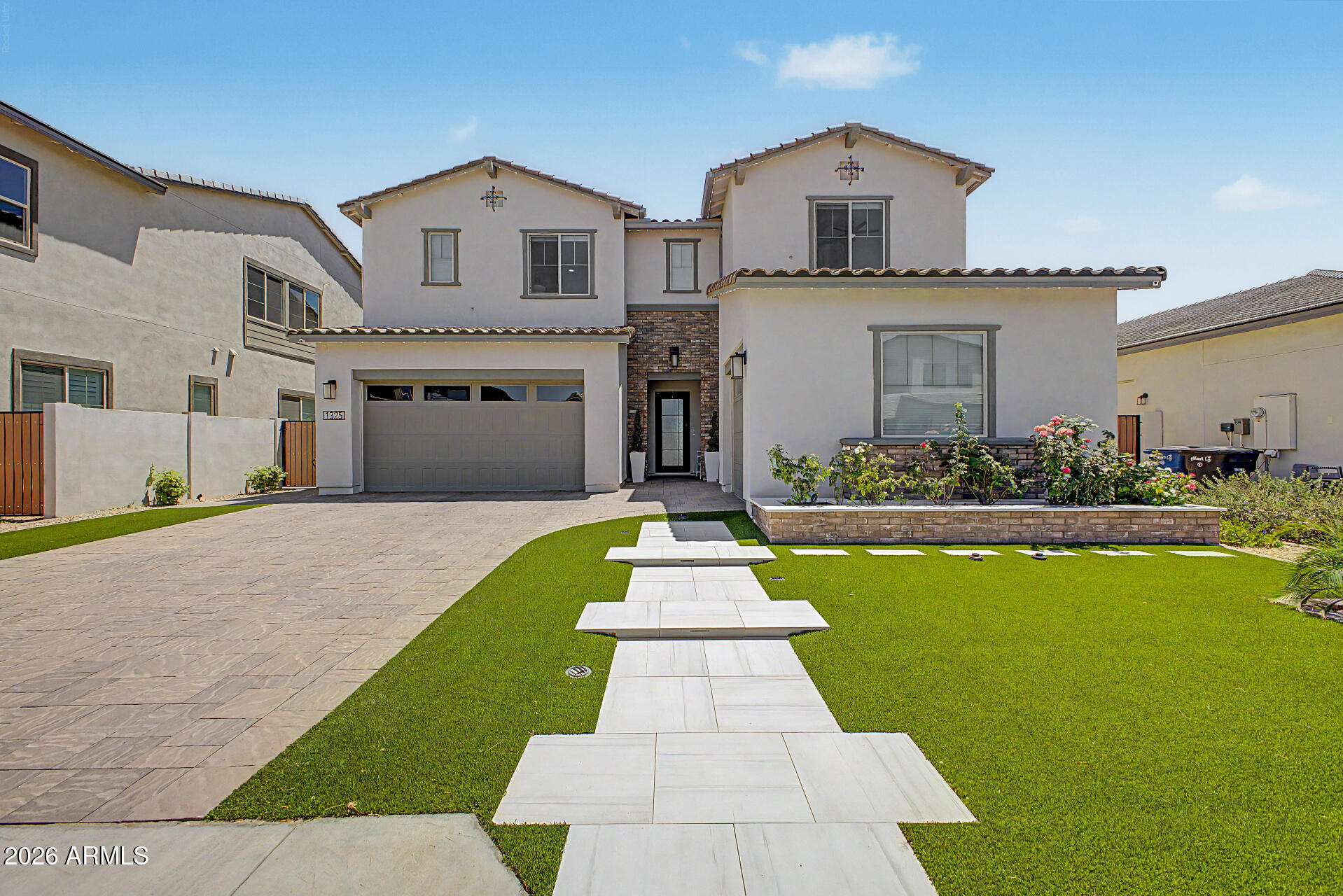 This stunning home is located in the  desirable 85298 zip code of South Gilbert & located within the highly esteemed gated community of Waterston. The nearly brand-new home shows like a model & boasts 5 bedrooms plus an office & a loft, along with 4.5 baths. Over $200k in builder upgrades & over $175k additional improvements! Step inside the foyer to soaring ceilings, stunning chandelier, abundance of natural light & an elegant entryway framed by beautiful custom millwork & molding throughout the home. The heart of the residence is the gourmet chef's kitchen, featuring a 5-burner gas cooktop, double ovens, large center island, quartz countertops, a spacious walk-in pantry & a convenient valet station. This seamlessly flows into the generous family room & dining area w/a 16' Center Pull Slider creating an indoor/outdoor feel! Beautiful porcelain plank tile throughout! The luxurious primary suite includes a frameless walk-in shower at Primary bath and a custom-designed walk-in closet. Additional highlights include 2 guest bedrooms with private en-suites perfect for in-law suite or teen retreat. All 5 bedrooms have walk-in closets! Mountain views throughout! Outside, the expansive backyard is an entertainer's dream, complete with an outdoor kitchen, water fountain, cozy gas firepit & an oversized marble deck. Garden areas w/citrus trees & more add charm. The home sits on a generous lot w/no homes behind & features a 3-car garage w/RV gate. 

This residence is nestled in the gated Waterston community, which offers outstanding amenities including community pools, a rec center, basketball courts, scenic lakes, playgrounds & walking paths. Top-rated Chandler Unified School District, specifically award-winning Rice Elementary.  

The home is located near the highly coveted Veteran's Oasis Park, with its hiking & biking trails, fishing, picnic areas & Science Center. 

Nearby shopping, dining, golf courses & easy freeway access. The area recently welcomed a new Lifetime Fitness and, coming soon, The Gilmore - Gilbert's exciting new dining & entertainment destination will be just moments away. This home delivers luxury living in one of South Gilbert's most sought-after communities.