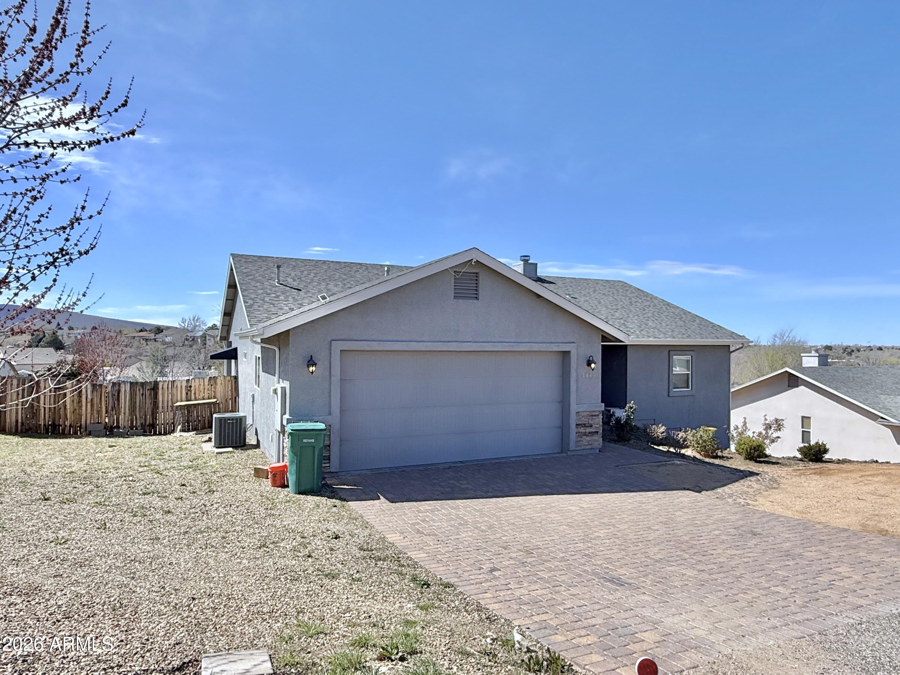 This home checks all the boxes! 2016 quality construction, open floorplan with NO steps, views of Granite Mountain, Glassford Hill and a greenbelt directly behind with biking and walking trails! Turnkey home with updated cabinets throughout featuring soft close, full extension drawers, kitchen island, granite countertops, LVP waterproof flooring, access to rear trex deck from great room, master suite and additional bedroom. This split plan also features a den for office, crafting or sitting room. Two tone paint, vaulted ceilings, extra parking, stacked stone corner gas fireplace, and no HOA! The master suite features dual vanity, walk-in shower, HUGE closet, linen and great views! Each room has a ceiling fans for maximum efficiency. Paver driveway plus circular gravel drive for extra parking and easy access. Close to Humboldt schools, easy access to 89A, dining, shopping and hospitals.