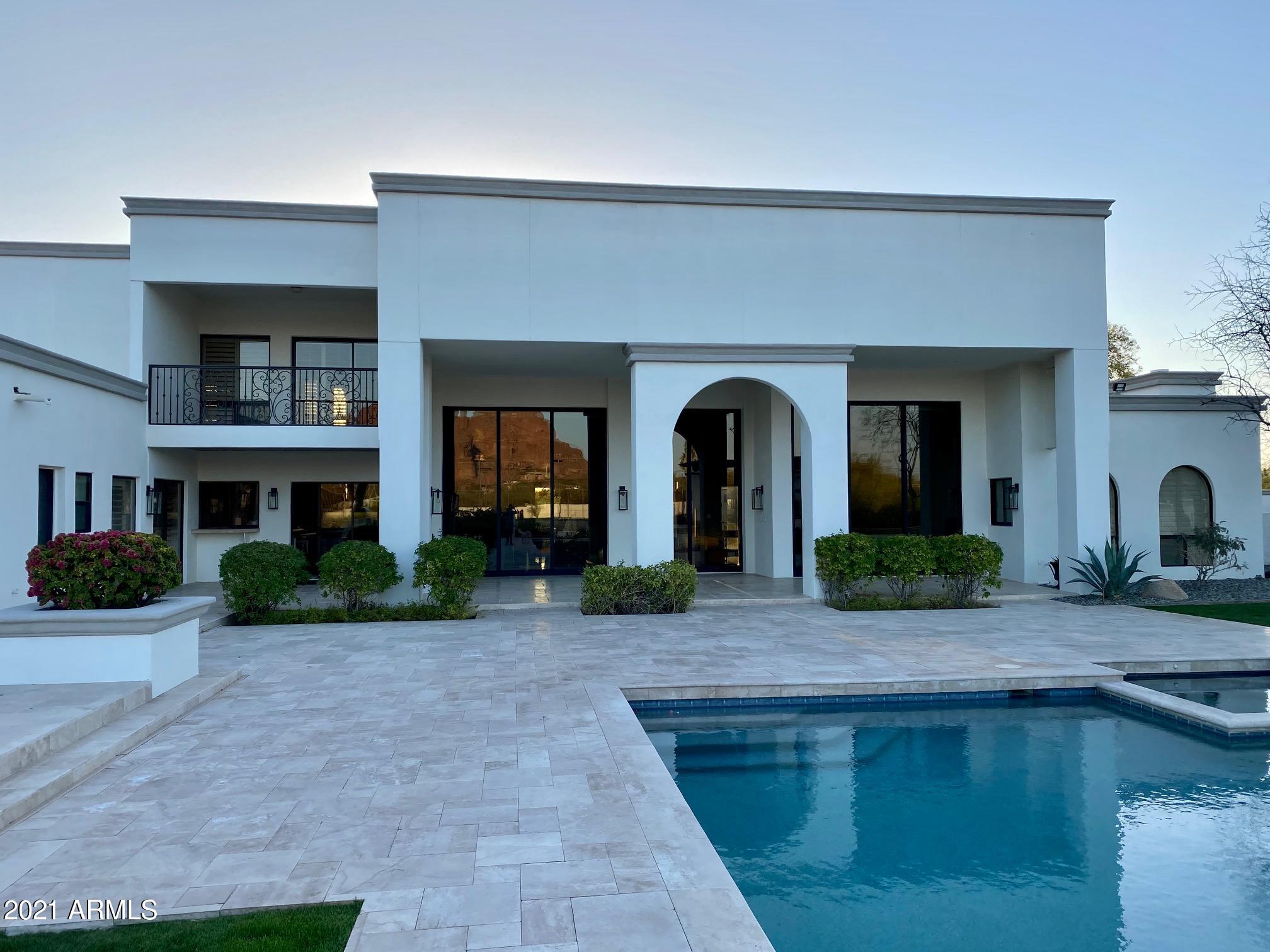 A view unlike any other in Paradise Valley. A 2.6 Acre flat lot home with views of Camelback mountain, Praying Monk, Mummy mountain, and Piestewa Peak. This 5 Bedroom, 6.5 bath home offers 12 ft towering sliders opening to a back yard like you have never seen before: a 50 ft diving pool, sand volleyball court, tennis court, basketball court, and enough grass to cool the summer evenings. And if it's winter time, then turn on the outdoor gas fireplace at the gazebo while the stars twinkle in the shimmering pool.