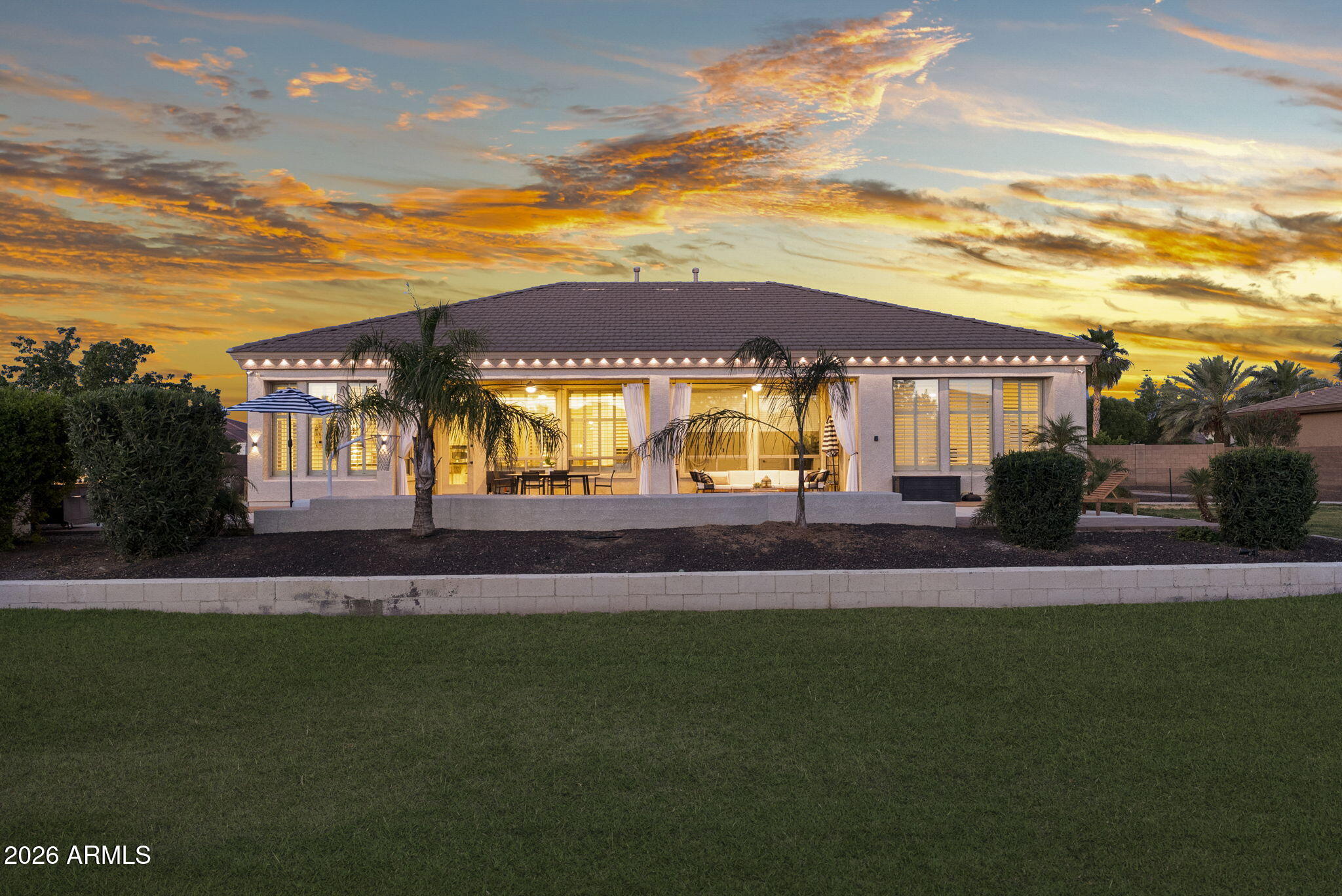 Located within the gated community of Estados at Seville, this exceptional estate sits on over 3/4 of an acre & offers 4,150 SF of beautifully designed living space. With 4 beds, 3.5 baths, & a thoughtfully laid out floor plan, this home blends space & versatility in one of the Southeast Valley's most desirable enclaves. Inside, you'll find a spacious & versatile floor plan featuring a dedicated private office & a large bonus/flex space ideal for a media room, playroom, or additional lounge area. The primary suite serves as a peaceful retreat, complemented by well-appointed secondary bedrooms that offer comfort & functionality for family or guests. A 4-car tandem garage provides exceptional storage. Step outside to a true backyard escape. Enjoy a sparkling in-ground pool & spa (cont.) a large covered patio ideal for year-round entertaining, and an expansive grassy yard that offers room to play, relax, or customize further. The oversized lot provides a rare combination of space and privacy within a gated setting.
Blending comfort, function, and outdoor living, this home offers a lifestyle that is both relaxed and refined inside the exclusive gates of Estados at Seville.