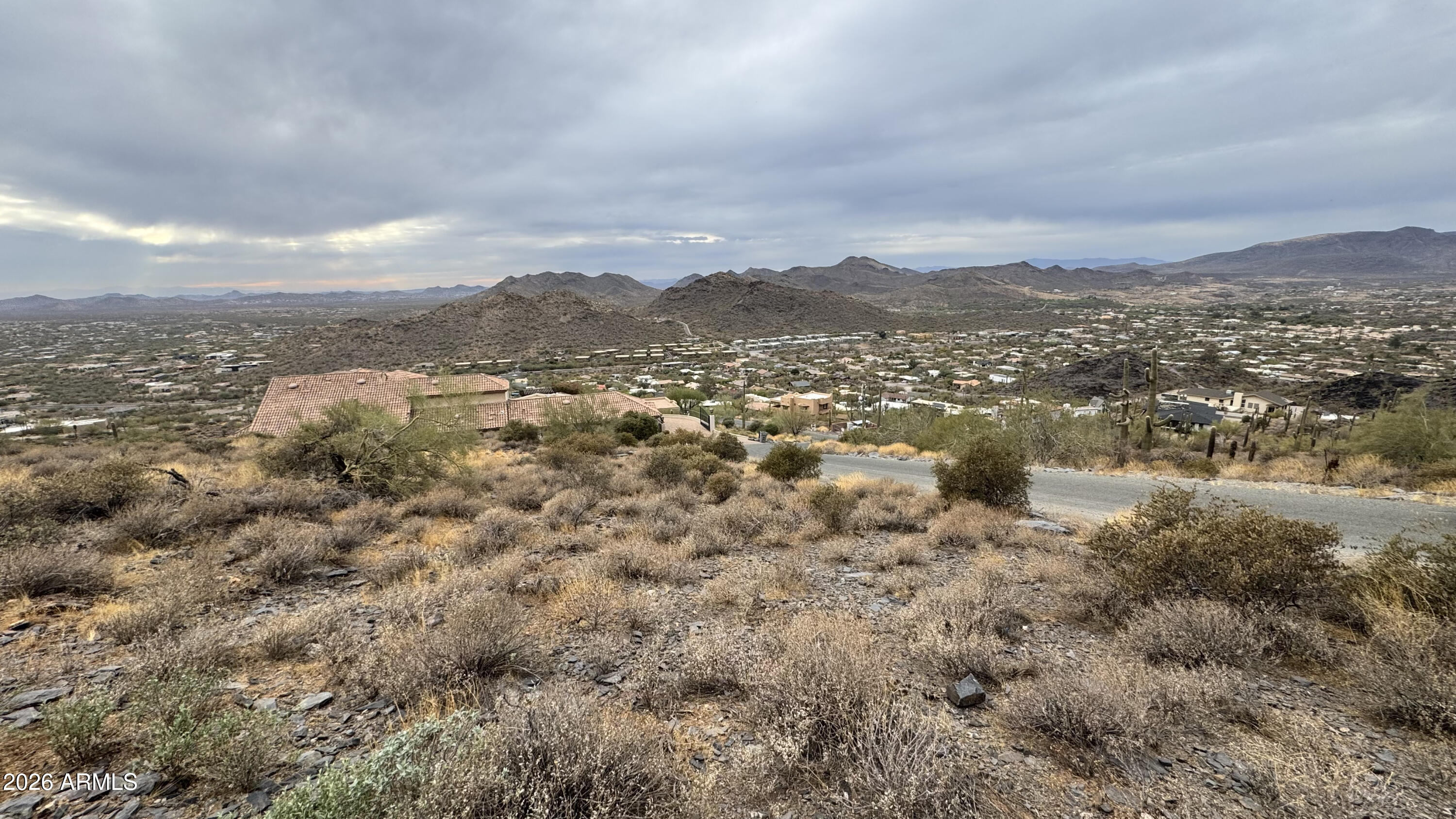 BUILD YOUR DREAM HOME WITHOUT THE WAIT. Perched atop Black Mountain, this 1.1-acre homesite captures stunning 180° views from Camelback Mountain to State Farm Stadium, with incredible Arizona sunsets. Fully approved building plans are in place, skip months of design and permitting and break ground immediately while still customizing finishes to your style. The proposed 6,717 sq ft luxury home is designed to maximize views and indoor-outdoor living. Offered as land only or as a complete build package with Standing Rock Construction. Rare, ready-to-build opportunity. Don't miss it!
