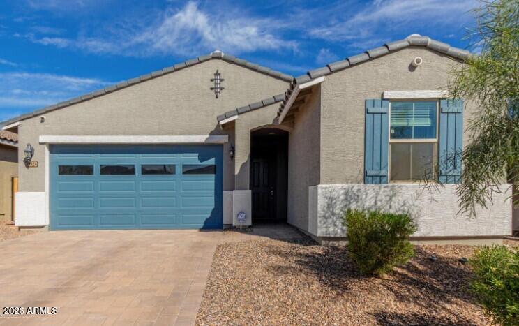 This 2023-built single-story home in the  sold-out subdivision of Canyon Views at the base of the White Tank Mountains, offering 3 beds, 2 baths, and 1,282 sq ft on a 5,287 sq ft lot. Open floor plan features tile throughout the common areas, plush carpet in bedrooms, and a kitchen with island, breakfast bar, granite countertops, and upgraded appliances. Split primary suite includes an extended step-in shower, dual vanity, and wrap-around walk-in closet. Solar already in place, and the backyard is a blank canvas with mountain views ready for your personal touch. Minutes from the Verrado community with shops, dining, and top-rated schools -- this is new construction value without the new construction wait. your dream outdoor living area while enjoying beautiful mountain views.