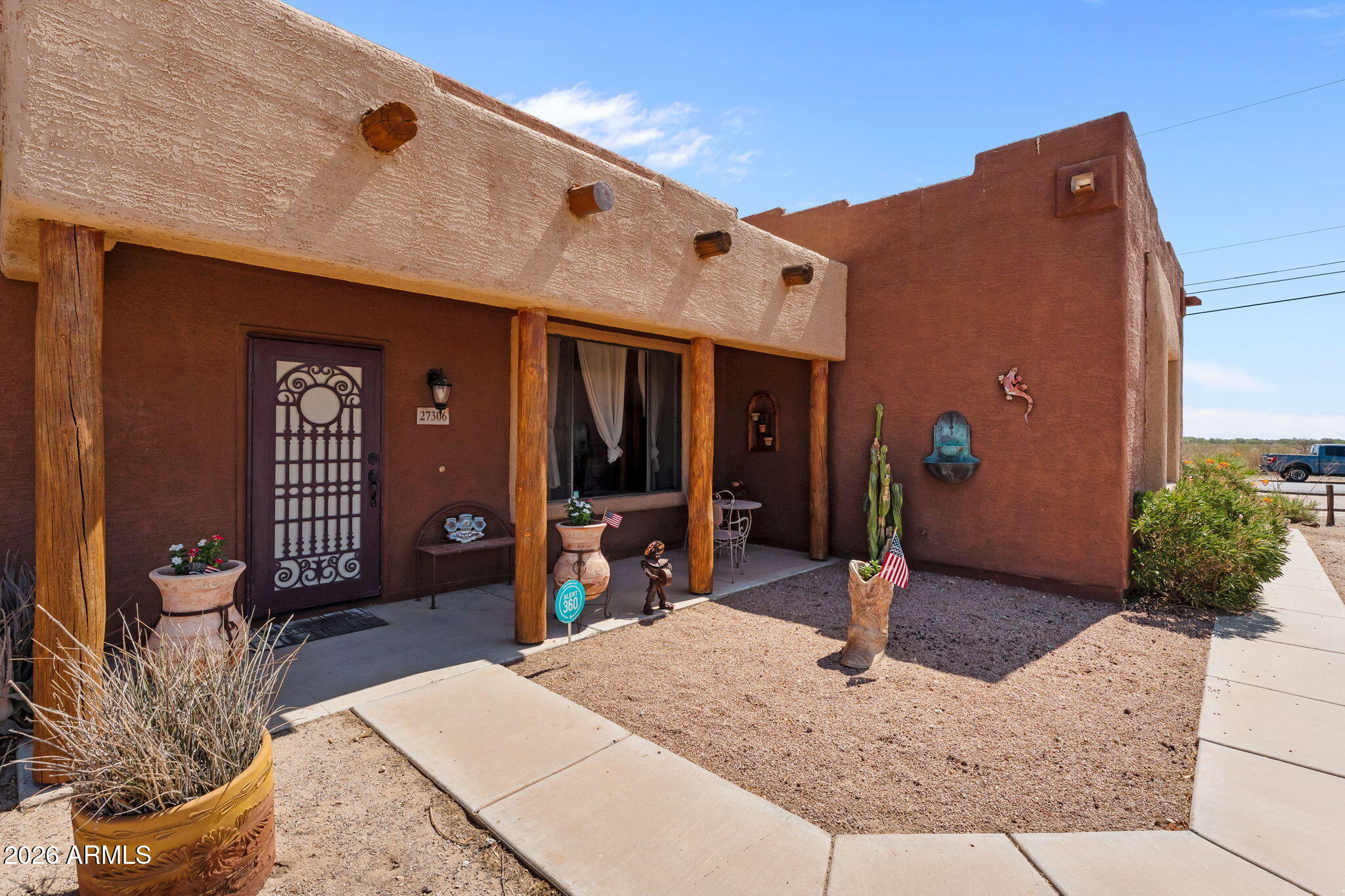 Experience Arizona living at its finest in this beautifully maintained Santa-Fe style home situated on 1.31 acres of horse property with desert and mountain views. Offering 2,082 sq ft, this fully furnished 4-bedroom, 2-bath home features a desirable split floor plan designed for both comfort and privacy.  Inside, you'll find warm real wood and tile flooring, stunning wood cabinetry, granite countertops, stainless steel appliances, and inviting living spaces filled with Southwestern charm. Major updates provide peace of mind, including a new roof in 2020 and HVAC system installed in 2021. Step outside and enjoy your own private retreat featuring an above-ground pool, spa, circular driveway, RV gate, and plenty of room for horses, toys, or future additions. The oversized 2-car garage provides added storage and convenience. 
Even better, all furnishings convey at no additional cost, making this truly move-in ready. Owned solar adds energy efficiency and low-cost bills!