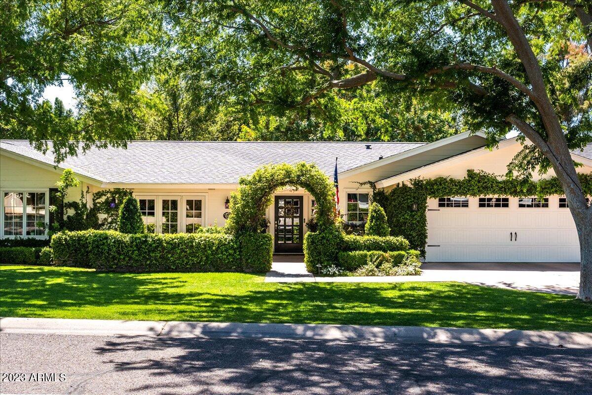 This exceptional residence, situated on one of the most desirable streets in Arcadia, is brimming with charm and personality.  The excellent curb appeal and lush landscaping creates the Arcadia allure.  The newly installed flooring flows seamlessly throughout the split floor plan, which is flooded with abundant natural light from the French doors and windows.  The kitchen features a large island with picturesque vistas of the backyard from the farm sink. Functional built-ins provide storage space and aesthetic appeal throughout the home.  The master suite is spacious, with beautiful views and access to the backyard, as well as a large bathroom with double vanities, a soaking tub, a walk-in shower, and a well sized closet.  Each of the spacious guest bedrooms features picture windows with views of the front or backyard.  The floor plan is expansive due to the large family room and additional teen room.  The backyard is an extension of the living space with plenty of room for entertaining and dining, a stunning brick fireplace, pool & spa, and lush greenery.