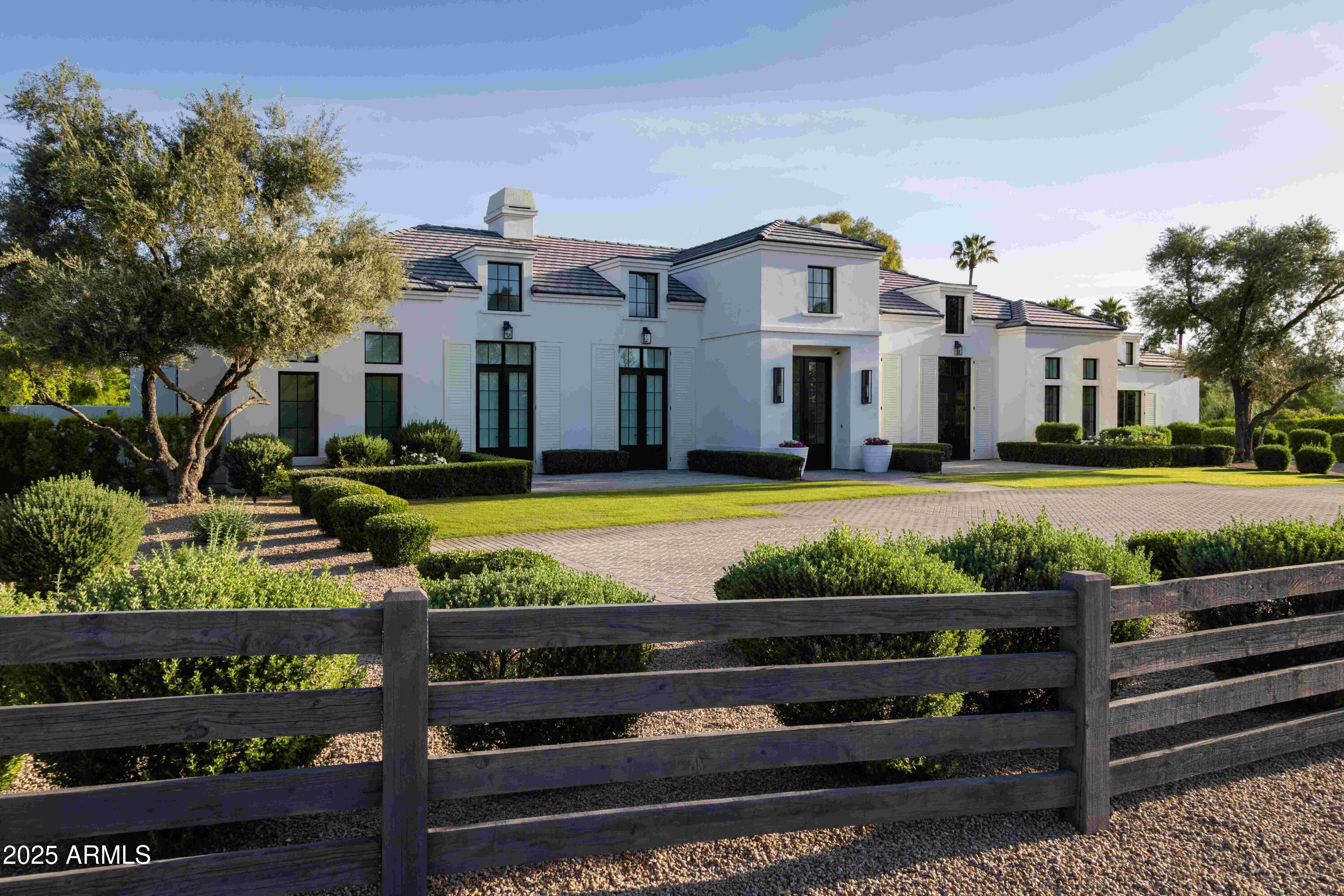 This private gated residence was built by the ultra-talented team at Brimley Development combined with the architectural excellence of Matt Thomas. Every impeccable space of this showpiece is absolutely spectacular. Dana Lyon of The Refined Group thoughtfully designed the interiors for her family with unique elements and incomparable attention to detail, and from the moment you arrive you'll be struck by the unrivaled beauty that begins with the grand entrance and continues throughout every inch of this exquisite home. The gourmet kitchen will satisfy any inspiring chef with the finest appliances featuring a La Cornue gas range with a custom stone hood. The large island is covered in chic white quartz and provides the perfect gathering spot, and a huge picture window above the farmhouse sink showers natural sunlight throughout, creating a very special space. In addition, the fully appointed butler's pantry has two subzero wine refrigerators and additional refrigerator/freezer drawers plus a Miele coffee station. The open floor plan features a sprawling great room with soaring ceilings accented by exposed wood beams adjacent to an elegant dining room perfect for formal and informal gatherings of any size. This area, the focal point of the home, is a showpiece beyond compare, and the primary suite is every bit as beautiful with a dream worthy closet and a spa-like bath with his/hers sinks, a large shower, free-standing tub and its own washer and dryer. The stunning home office will make working from home the preference. In addition to the main house, the same exceptional design carries through to the casita with another bedroom, fireplace and workout room. The finest finishes imaginable include wide plank wood flooring, custom lighting, sleek quartz and marble surfaces, pristine millwork, stone accents, and Control4 smart home automation. As if the home itself isn't inspiring enough, the grounds will blow you away with pristine landscaping, meandering rose bushes, a 25-meter lap pool, built-in barbecue and beautiful ramada with a gas fireplace. In addition to every special amenity already listed, the home is solar powered by a system that is owned outright with an air-conditioned garage and has lovely Camelback Mountain views. If you appreciate the upmost quality and relish in impressive design, your home search may have just ended because this extraordinary home is perfect in every way!