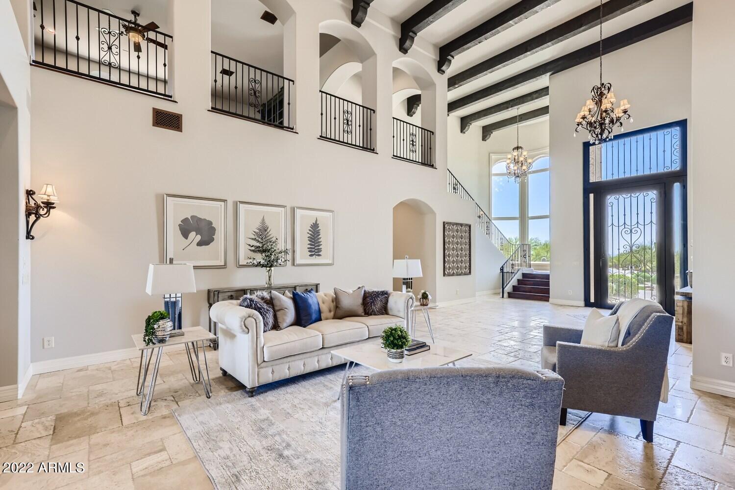 A Santa Barbara style private desert sanctuary in exclusive north Scottsdale gated community of only 8 custom homes, at the base of Lone Mountain, where extreme privacy is coupled with incomparable far-reaching views. The grand interior features 24-ft beamed ceilings, custom millwork, Canterra stone fireplaces, travertine and wood flooring. The elegant open floor plan provides seamless indoor outdoor living with two expanding walls of glass that open onto a huge resort-style outdoor living area, complete with kitchen, bar, diving pool, spa, water feature and fireplace. The interior floor plan flows beautifully to provide an entertainers dream with several separate areas to host in. The home includes a bar and game area, wine room, massive master suite upstairs complete with a patio with expansive mountain views. This is one you have to see to appreciate the grandness and custom features of this stunning custom home.