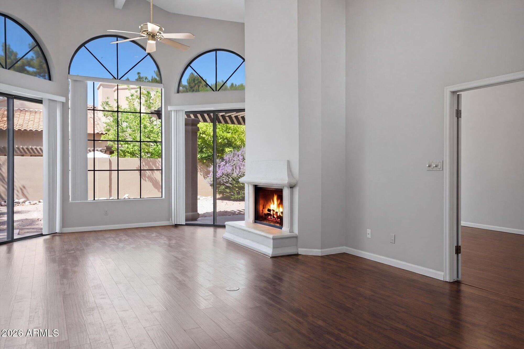 Great Opportunity in a sought-after guard-gated patio home community. End unit with soaring ceilings, abudant light, and a spacious great room with fireplace plus formal living/dining. Updated Kitchen with newer appliances and upgraded countertops. Wood laminate flooring throughout, Primary Suite with walk-in closet and remodeled bath with quartz vanity and shower. Large second bedroom fits a king bed. Inside Laundry and 2 car garage. Major updates include Roof, HVAC, and Water Heater. Community features heated pool/spa, tennis, pickleball, and HOA-maintained front yard. Adjacent to Stone Creek Golf Course and close to shopping, dining and a city park!