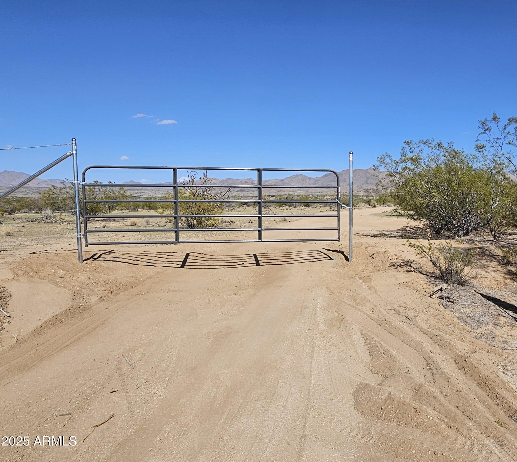 Backs to state land on two sides! This 37.892 (thirty seven point eight nine two) acre parcel is currently zoned agricultural-residential and has commercial potential. Over 2200 feet feet deep. Access off of  Silverado Parkway, (approximately 100 feet wide) and Cofer Ranch Road. The parcel is generally level with seasonally active washes entering on the northwest corner.  Southern border has a utility easement with power lines approximately  1 mile. Survey recently recorded in 2025-024355. Parcel 21F-2.  Seller may carry with good down payment.  Great views, a few trees, nice ridgeline for elevated building area and unlimited potential.