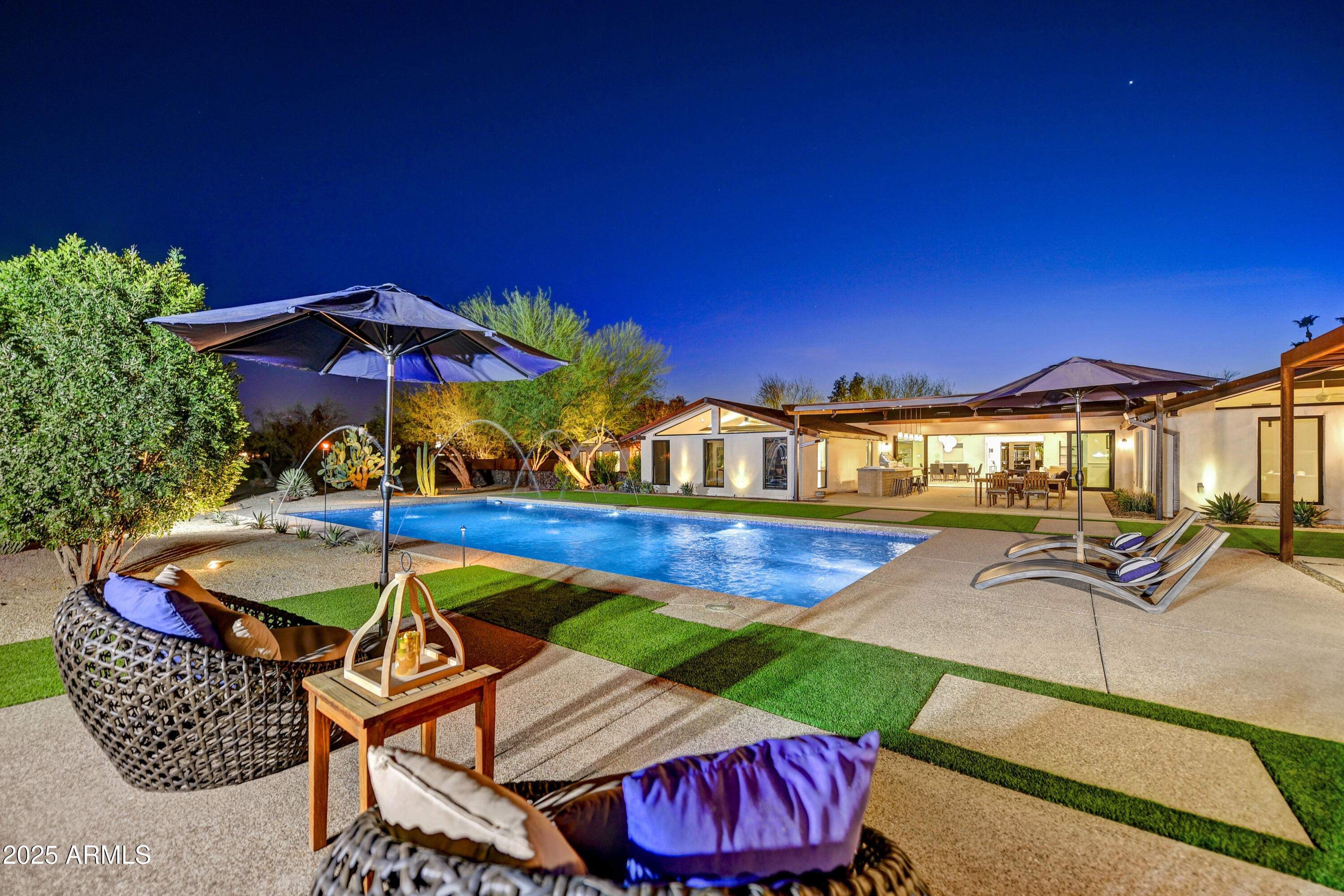 Experience elevated living in this exceptional Scottsdale estate, set on a rare subdividable 2.14-acre lot backing the 2nd hole of Starfire Golf Club. This property offers 6,664 sq ft of refined space with 5 ensuite bedrooms, a private guest suite with full kitchen and separate entrance, and a flexible studio ideal for a gym, theater, or creative retreat. The open-concept design features soaring truss-beamed ceilings, expansive windows, and a chef's kitchen with Thermador appliances, quartzite counters, and a walk-in pantry with second freezer. Enjoy seamless indoor-outdoor living with multiple courtyards, mature landscaping, artificial turf, and an outdoor kitchen with natural gas. The estate's development potential is unmatched—perfect for adding casitas, a sculpture garden.... ...... or subdividing for future investment. With direct golf course access and proximity to Scottsdale's top dining, shopping, and entertainment, this home offers luxury, flexibility, and opportunity in one of Arizona's most coveted neighborhoods.