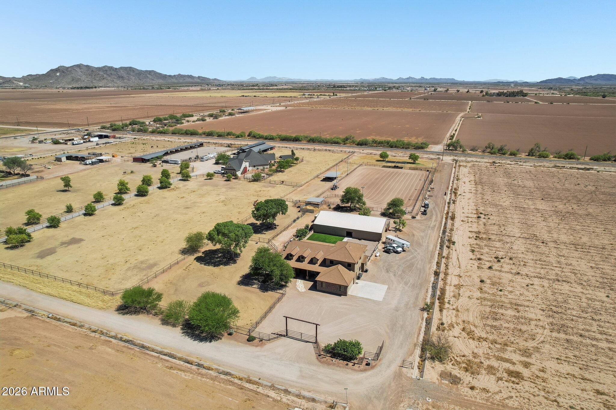 Peaceful country living just minutes from town. This is the horse property you've been waiting for. With 3,294 sq ft on just under 5 acres, this home has it all. Inside you'll find tailored finishes, a great split floor plan, custom cabinetry, built-in ovens, cooktop, and granite counters. Four spacious bedrooms each have their own bathroom, plus a dedicated office. The primary suite offers a standalone tub and walk-in shower. Enjoy a fully covered patio and landscaped walkway leading to a lighted 50'x80' barn with seven 16'x16' stalls, wash rack, and tack room, a full-size lighted roping arena, shaded cattle pens, irrigated pasture, and mature trees--an ideal setup for any horse enthusiast. Must see to appreciate all it has to offer.