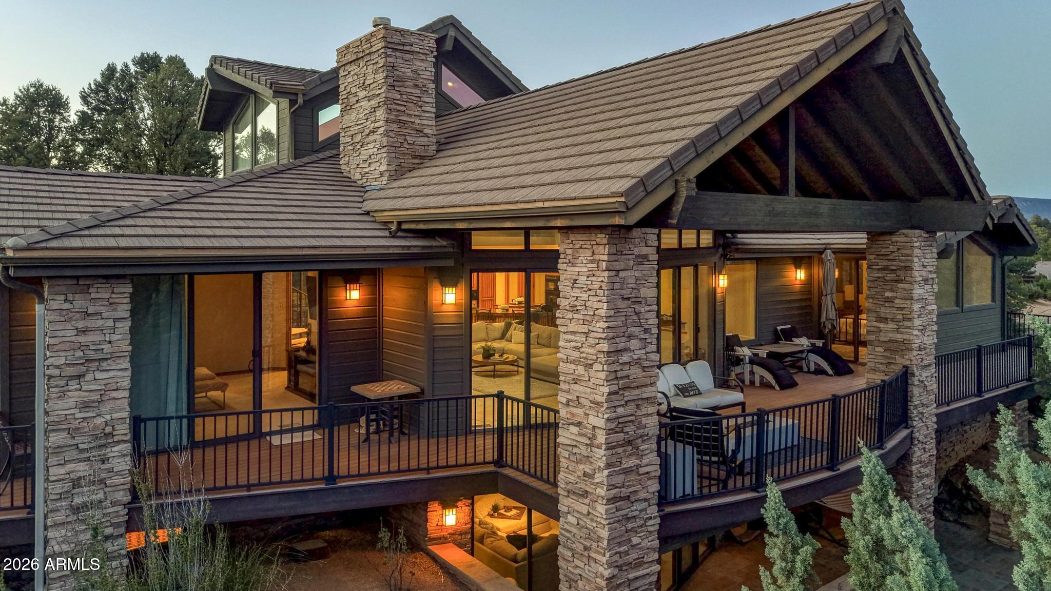 Located in the prestigious gated golf course community of The Rim Golf Club, this beautifully designed 4,020 sq ft mountain retreat offers luxury living surrounded by towering pines and scenic mountain views. Situated on over 1/3 of an acre, this spacious home features 3 bedrooms on the main level plus a loft with incredible views and built in office space, along with 3 bathrooms and multiple indoor and outdoor living spaces designed for entertaining and relaxation. The kitchen is well-appointed with granite countertops, a large island, expansive breakfast bar, microwave/convection oven, steamer, and abundant cabinetry. The open living area showcases stunning tongue and groove ceilings, a dramatic stone propane fireplace, and a large dining room perfect for gatherings. Enjoy the outdoors from the expansive rear deck with mountain views or unwind on the additional patio complete with a built-in spa, TV, BBQ area, and outdoor dining space. The lower level includes a spacious great room with private patio access, wet bar with refrigerator, and a 3/4 bath--ideal for guests or entertaining. Additional features include a 2.5-car garage with golf cart space and extensive built-in cabinetry on nearly every wall.
Conveniently located near the fitness center, tennis courts, Mountain Spa, and clubhouse. Offered fully furnished for a true turnkey mountain lifestyle opportunity.
