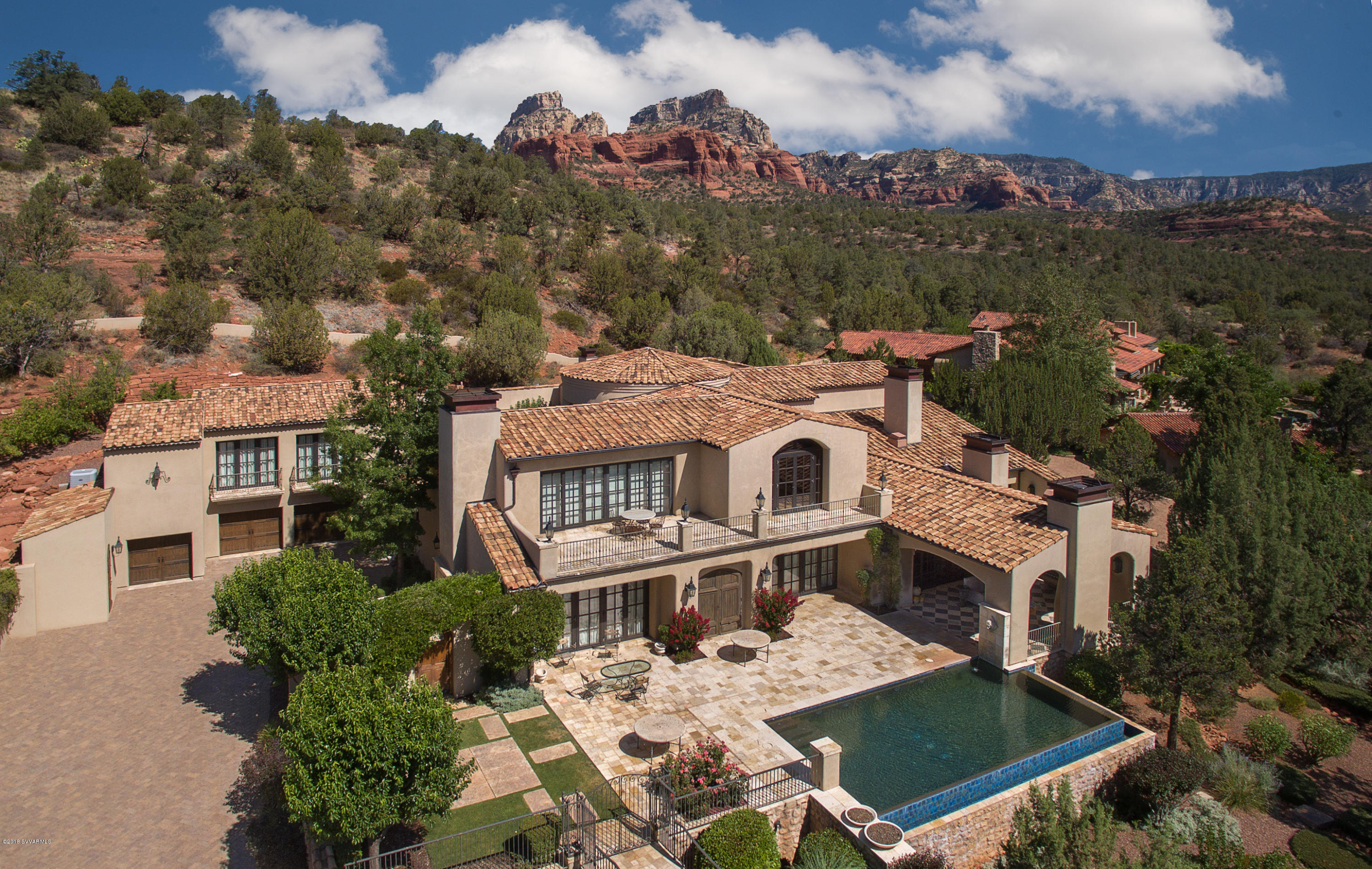 Private, nestled Sedona luxury property backing to National forest situated on an oversized estate lot with perfectly manicured landscaping with the finest amenities available.  Marvel at the panoramic red rock vistas of the Secret Mountain Wilderness area  from this property bordering on Coconino National Forest.  Situated behind double gates for privacy in the exclusive area of Seven Canyons, this sprawling villa was designed and constructed by the finest artisans and the level of finish will impress well-heeled owners looking for a European Villa getaway surrounded by the upper Sonoran Desert. For neighborhood info see: www.sevencanyons.com