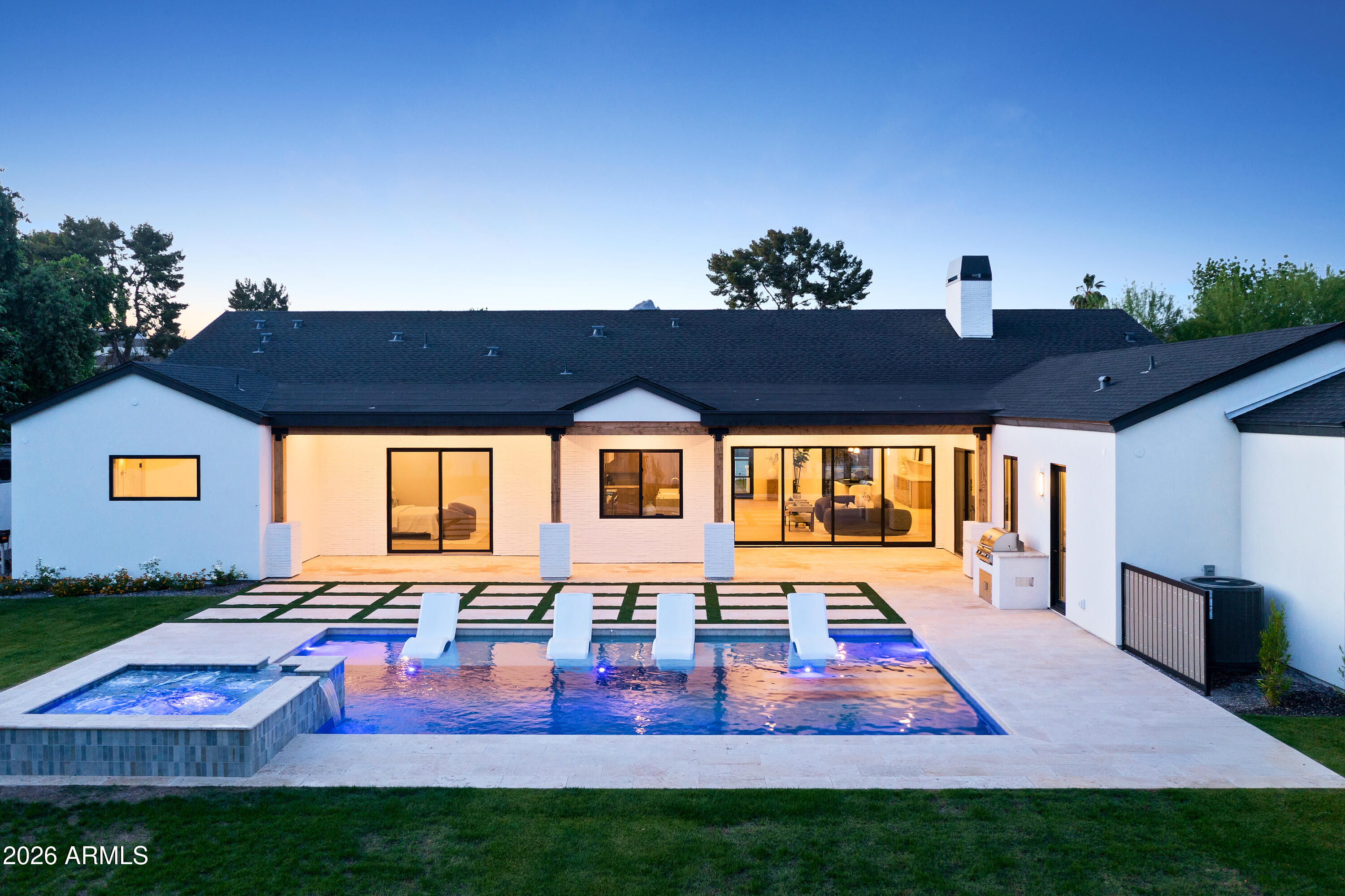 NEW CONSTRUCTION in Biltmore/Arcadia on a rare 16,000+ sqft lot. This thoughtfully designed home blends quality craftsmanship with timeless modern finishes and seamless flow. This open floor plan offers five ensuite bedrooms, a powder room, dedicated pool bath, and a large bonus room. The kitchen features a full Wolf/Sub-Zero package, Taj Mahal quartzite, LED lighting throughout, and an impressive butler's pantry. Additional highlights include Control4, TnG ceilings, and pre-wiring for motorized shades. The massive private backyard showcases a heated pool and spa with an extended baja shelf, 1,300 sqft of travertine pavers, and mature landscaping. Oversized three-car garage, RV parking, & located in a quiet well-established neighborhood.