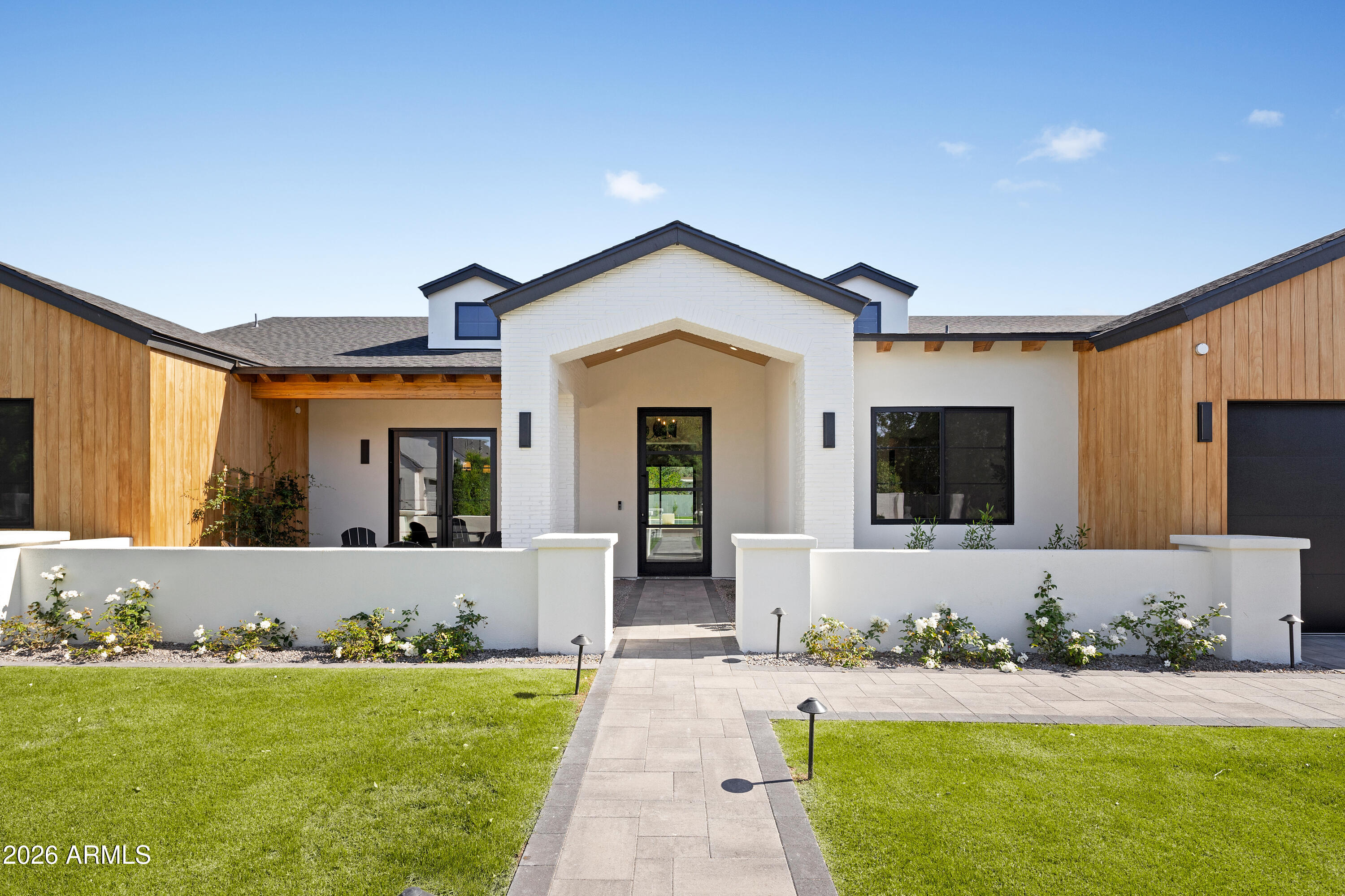 NEW CONSTRUCTION in Biltmore/Arcadia on a rare 16,000+ sqft lot. This thoughtfully designed home blends quality craftsmanship with timeless modern finishes and seamless flow. This open floor plan offers five ensuite bedrooms, a powder room, dedicated pool bath, and a large bonus room. The kitchen features a full Wolf/Sub-Zero package, Taj Mahal quartzite, LED lighting throughout, and an impressive butler's pantry. Additional highlights include Control4, TnG ceilings, and pre-wiring for motorized shades. The massive private backyard showcases a heated pool and spa with an extended baja shelf, 1,300 sqft of travertine pavers, and mature landscaping. Oversized three-car garage, RV parking, & located in a quiet well-established neighborhood.