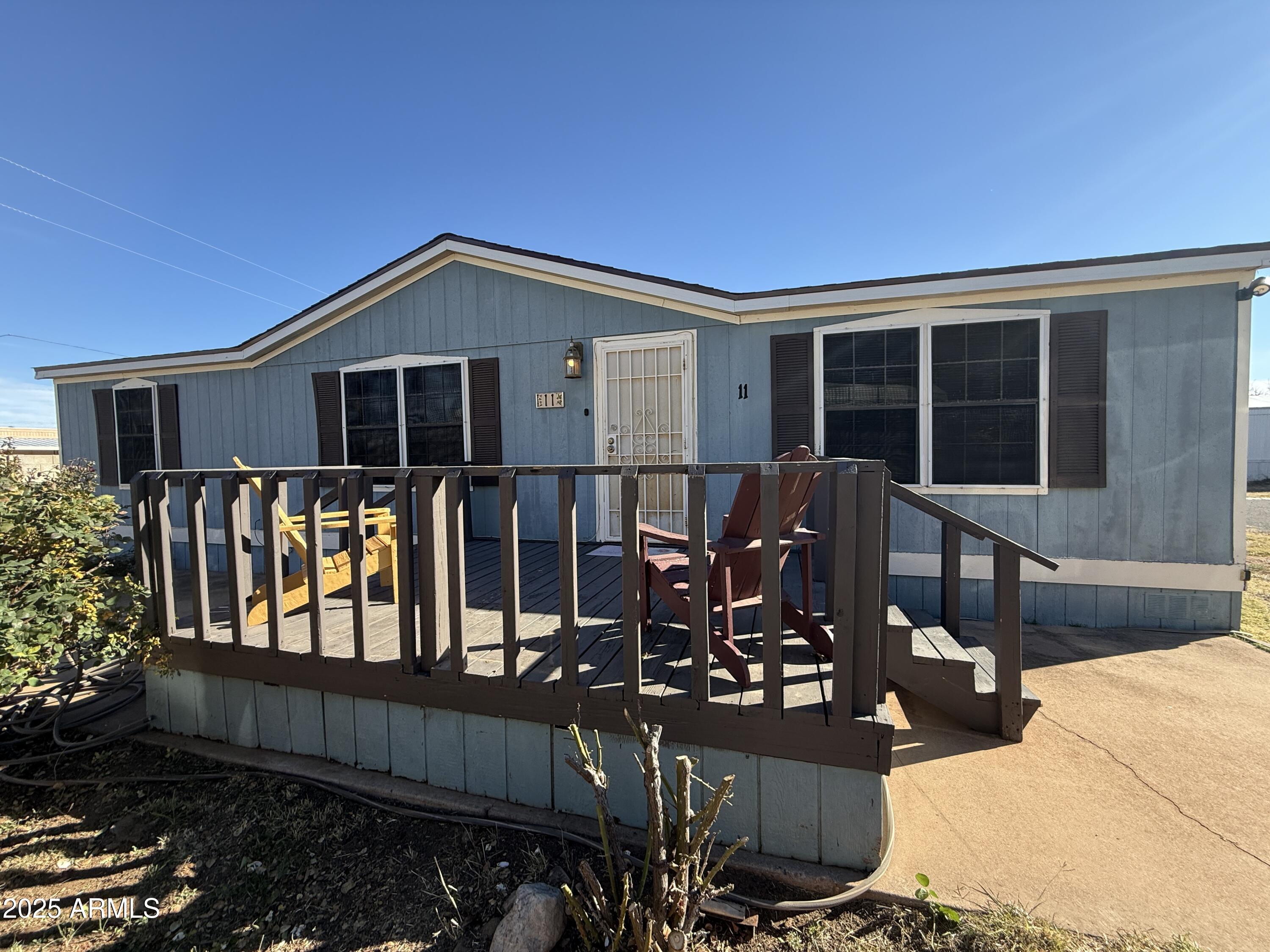 House sits on a corner lot with rose bushes in front, 3 bedrooms and 2 full baths, deck in front for enjoying mountains and sunsets. Washer and dryer stay with home, most rooms have a ceiling fan, there are mini blinds and rolling shades in windows. Primary bathroom has a soaking tub, security door on front and back doors, floors are engineered wood and carpet. Located in a small manufactured home park that is quiet and quant.