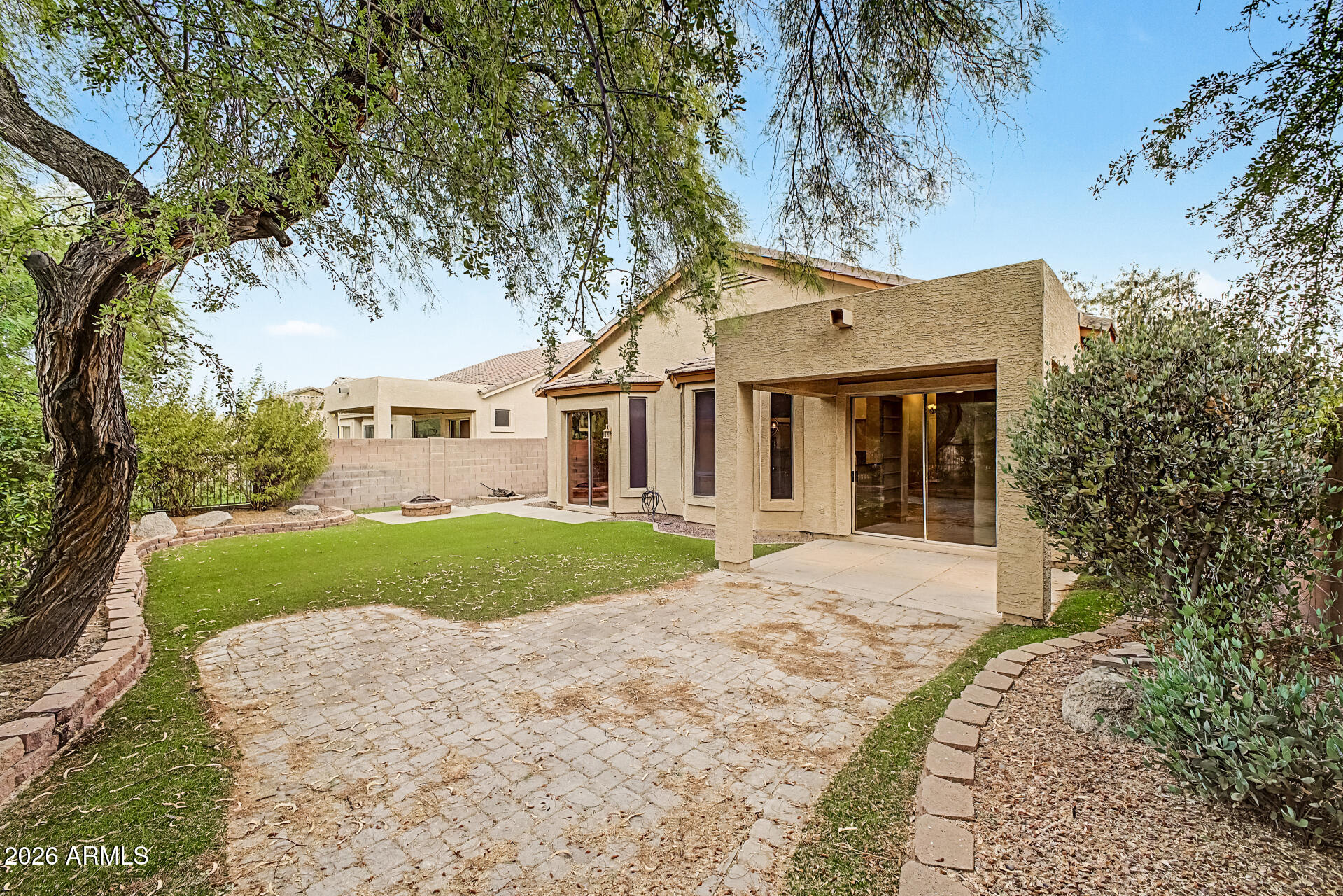 This beautiful single-level home has 3 bedrooms and 2 bathrooms, and sits in the award-winning, gated Las Sendas golf course community. It is close to a pool and spa, tennis and pickleball courts, a playground, and the elementary school. The home features vaulted ceilings, plantation shutters, and a split floor plan. The owner's suite has its own exit to the backyard and a spacious ensuite with a separate soaking tub and shower, double vanities, and a large walk-in closet. The other two bedrooms are roomy and private. The kitchen includes stainless steel appliances, a gas range, Corian countertops, and a family dining area. All appliances are included. Outside, you'll find a large covered patio, mature landscaping, and easy-care turf. The backyard opens to a private wash. This home is in a great spot for dining, travel, shopping, top-rated schools, and many other amenities.