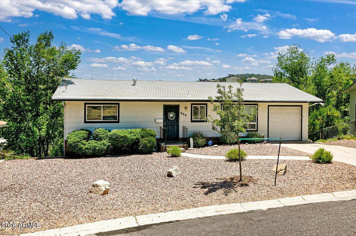 Located just a quarter mile from the iconic Yavapai County Courthouse Plaza, this charming contemporary-style gently lived in second home blends timeless character with an unbeatable downtown lifestyle. Built in 1965 and offering approximately 2,000 square feet, this four-bedroom, two-bath residence is within walking distance to Prescott's vibrant restaurants, shopping, entertainment, and year-round community events. Inside, warm hardwood floors create an inviting atmosphere, while the lower level offers exceptional flexibility with a spacious family room featuring a wood-burning fireplace, laundry room, and additional space ideal for a hobby room, workshop, studio, or creative retreat. The thoughtful layout provides room for both everyday living and entertaining. A single-car garage adds convenience, and the incredible location places you just moments from everything downtown Prescott has to offer -- from courthouse events and local dining to hiking, biking, and boutique shopping. This is a rare opportunity to enjoy classic charm, versatile living space, and one of Prescott's most walkable locations. Most Furnishings convey at COE for no value.