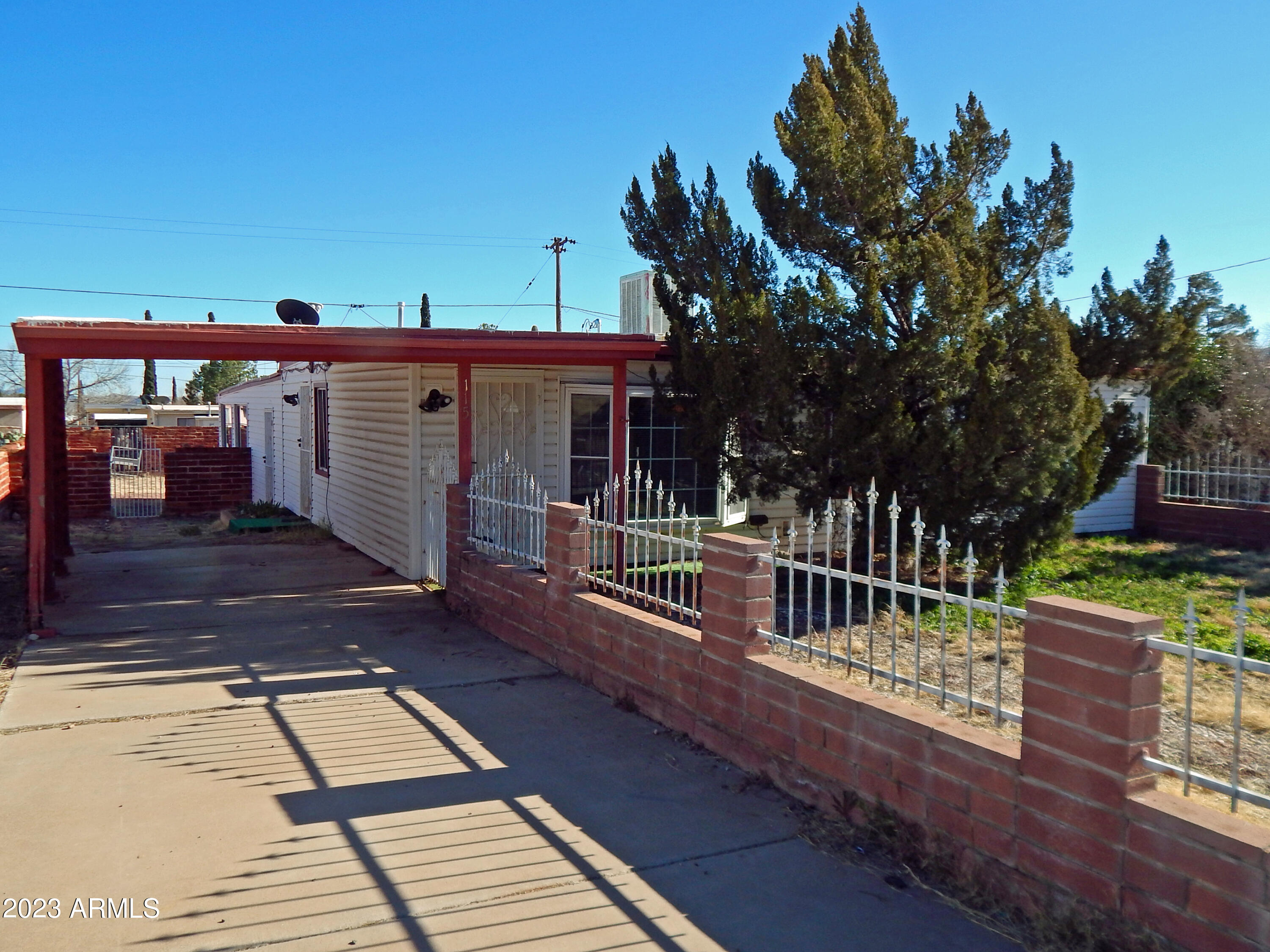 Priced To Sell Now!!  This 954 sq ft., 3-bedroom 1 bath home has been updated with new cabinets, windows, carpet, doors and interior paint.  There are security doors and ample parking, including a carport with kitchen access; on the other side of the home there is a double gate for full access to rear of the home or parking for your RV.  Approximately 10-15 years, septic was replaced.  In addition to the main house there a 2-bedroom 1-bath structure.  That 627 sq ft brick 2-bedroom 1-bath guest house needs work as you can see from the pics.  It is wired for electric but needs to be connected to the new panel on the front house.  Sale subject to verification of ownership status.