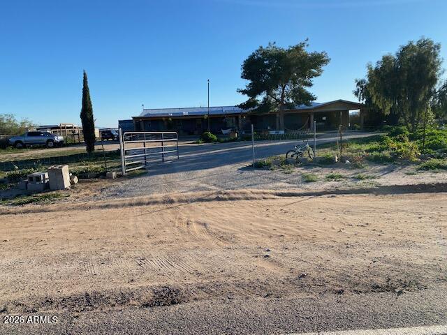 Great manufactured family home on approximately 1.2 fenced acres. Beautiful Mountain views. This home features a formal dining, family room and living room. Large upgraded kitchen with tons of cabinets. Porcelain tile throughout and carpet in bedrooms. Master bedroom is split. Master bath has a garden tub and double sinks. Large laundry room with backyard access. Property has lots of mature trees. 2 car garage with 2 car covered parking. Upgraded front patio with concrete flooring. Plenty of room for the kids and the horses as well ! Walking distance to Elementary school. Only a 20 minute drive to Lake Pleasant.