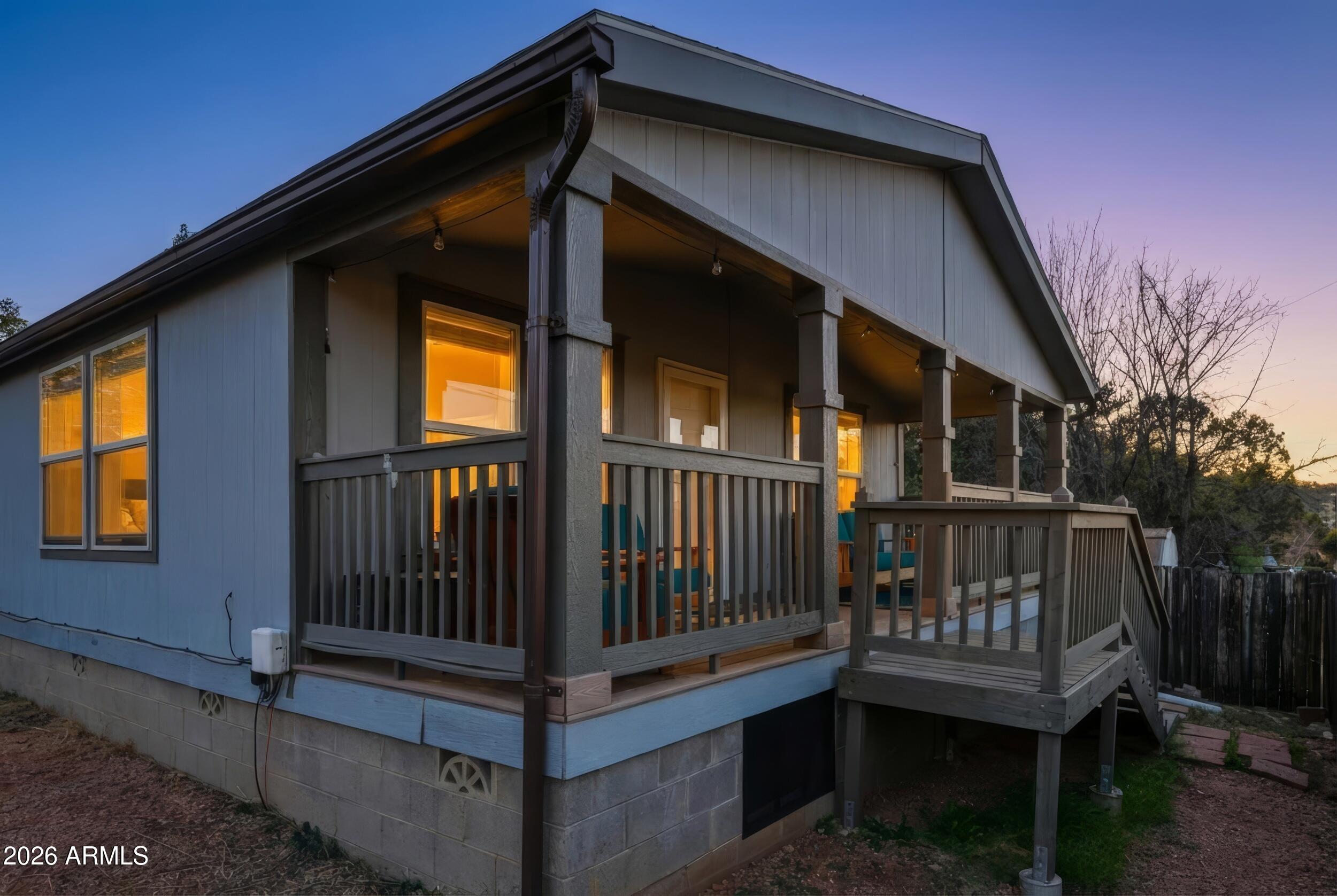 This well-appointed 2017 Cavco home features a meticulously maintained interior with a spacious open layout and vaulted ceilings. Durable laminate flooring runs through the kitchen, dining, and main living areas. The kitchen offers a central island, ample cabinetry, a large pantry, and upgraded appliances including a refrigerator, dishwasher, washer, and dryer. The standout feature is the outdoor living space--a maintenance-free covered front deck perfect for relaxing and taking in stunning, unobstructed views of the Mogollon Rim. Enjoy morning coffee or sunset views against a beautiful Arizona mountain backdrop. Fully electric, permitted, and equipped with installed tie-downs, this move-in ready home is ideally located to enjoy the best of Payson. Owner/Agent.