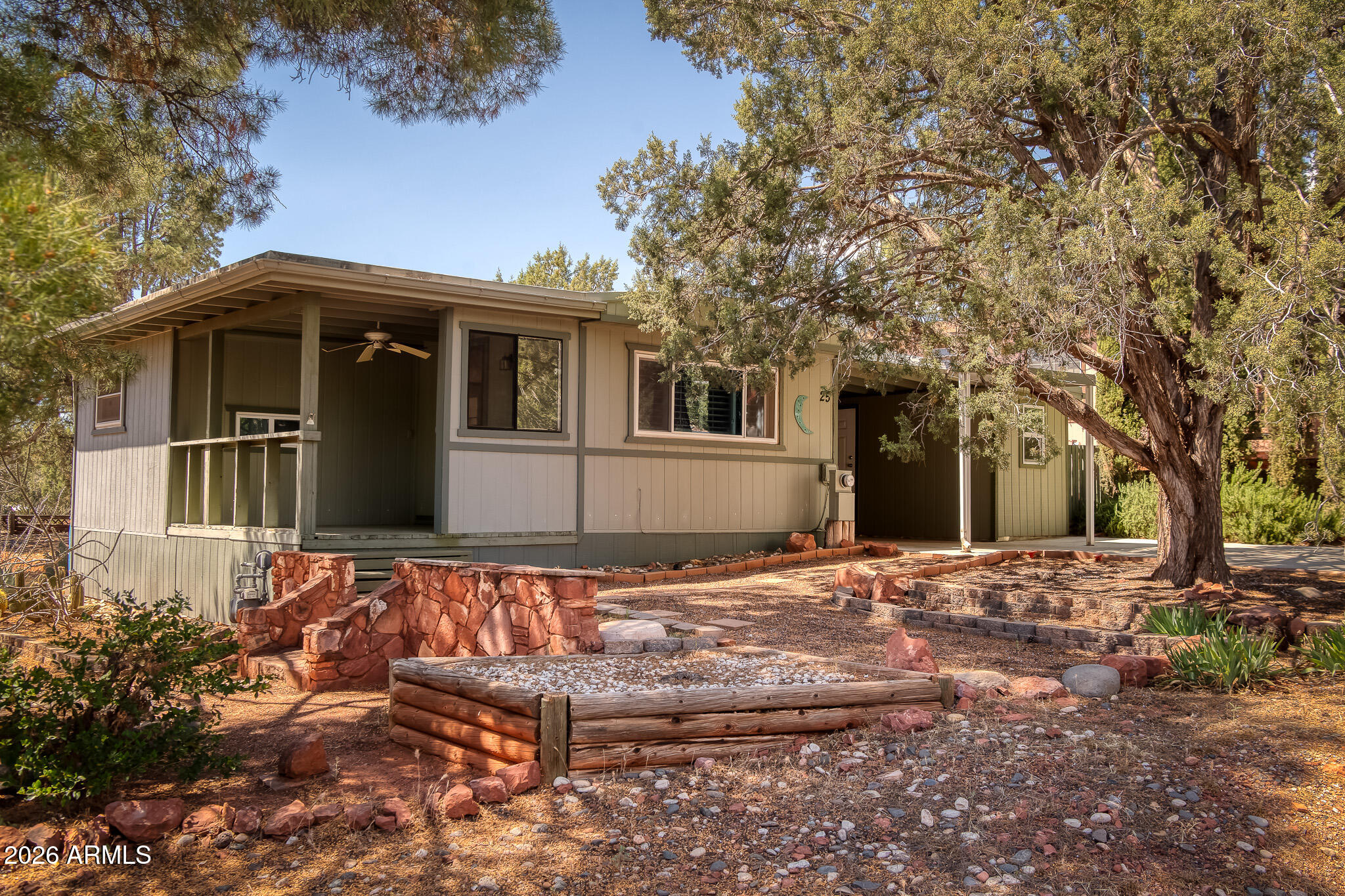 Privacy and Potential in the Heart of West Sedona!
Discover the perfect blend of central convenience and privacy. This light, bright, and airy two-bedroom, two-bathroom home offers privacy, nestled against open space on two sides, with the freedom of no HOA. The home is move-in ready and meticulously cared for. The kitchen has stainless steel appliances and wood flooring. The family room is bright and light. The primary suite has a large walk-in closet with automatic lighting. The second bedroom has a warm wood ceiling. Throughout the home, skylights and ceiling fans enhance the airy feel, and a separate, oversized laundry room complements them. 
The outside is wooded and private. Whether you are looking for a primary residence or a short-term rental, the location is unbeatable. You are steps away from community parks, world-class hiking and biking trails, and the best dining and shopping Sedona has to offer. The property has a well-built shed off the carport, providing space for a workshop or storage. This is a must-see to appreciate!