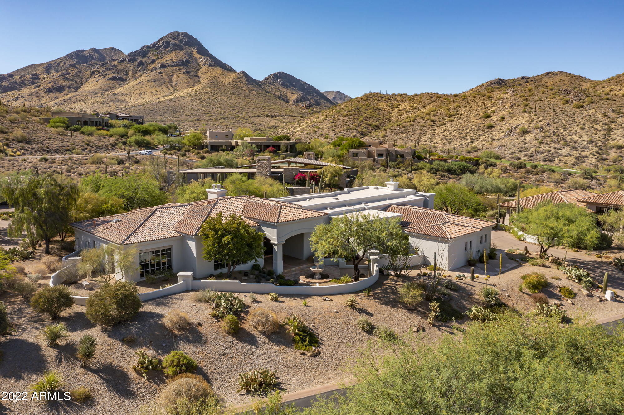 ****A Santa Barbara Mediterranean Exudes Modern Relaxed Elegance**** This stunning German Robledo designed Salcito Custom home resides in the gated community of Glenn Moor In Troon Village encompassing the ''back nine'' of the Tom Weiskopf course at Troon Country Club. The home sits prominently on a premier elevated 0.82 acre mountain view lot affording panoramic views of the McDowell Mountains, Troon Mountain, Pinnacle Peak and the north Valley beyond. The home is ''sun aware'' and well situated on its lot for light and shade, with a spacious veranda that looks out to a heated negative edge salt water pool and spa with the dramatic McDowell Mountain Preserve serving as backdrop. The Master Suite is a private oasis on the north side of the home with an oversized bedroom with fireplace, 2 master baths with steam shower, an outstanding master closet by Classy Closets, a Library and bonus room. The exceptional Library creates drama for the house from street level by means of a full wall, floor-to-ceiling, under shelf LED lit bookcase and adjoining built in desk by Woodesign, one of the Valley's premier wood shops.

The current owners completed an extensive six-figure remodel in 2019, thoroughly updating and modernizing every facet of the home's interior design and mechanical infrastructure. A thoughtful remodel retained elements installed by the original owner, a prominent flooring and tile executive, that add Mediterranean ambiance to the home including stained ceiling beams, an imported Italian herringbone floor in all common areas, and high end rustic tile work in the guest baths. High attention to detail was paid to all decorative features, as example, all diffuser vents were upgraded to luxury level quality.

Features added to the home include a gigabit speed wire mesh network, Control 4 Full Home Automation, a 7.1 media Family room with full house audio, a true Chef's Kitchen featuring Wolf steam and bake ovens, microwave and induction cooktop, Subzero Ice Maker, and Miele built-in Espresso Machine. A spacious Dolomite stone island and prep sink becomes the gathering point in the Kitchen complemented by surrounding Denali Quartz countertops and ample display cabinetry. Three limestone gas fireplaces in the Family, Great Room, and Master Suite were designed by the master stoneworks firm Atelier Jouvence of Chicago. Each Bedroom has an ensuite bathroom with luxury Dornbracht fixtures, new hardwood red oak plank floors by Mirage, and closets by Classy Closets. The discerning buyer will appreciate the extensive upgrades to the home's infrastructure including installation of a whole house Water Purification System utilizing TAC (template assisted crystallization), 3 Carrier Performance Series HVACS and furnaces run with Nest thermostats, 2 Bradford White water heaters, a central vacuum by Element, and all new pool equipment (including 3 Jandy pumps, Jandy heater, filter, and salt cell all controlled by iAqualink pool automation). The pool equipment enclosure is covered by a pergola by Royal Covers. The home's smoke detectors and glass breaks are new and monitored by AAA SmartHome.

The Glenn Moor Club includes a clubhouse, pool, tennis and pickleball court, and shuffle board courts. The Troon Country Club sits just to the north of Glenn Moor and the Four Seasons Resort at Scottsdale Troon North is minutes away. World class hiking, including Pinnacle Peak Park and Tom's Thumb trailhead, along with exclusive shops and dining are in close proximity.