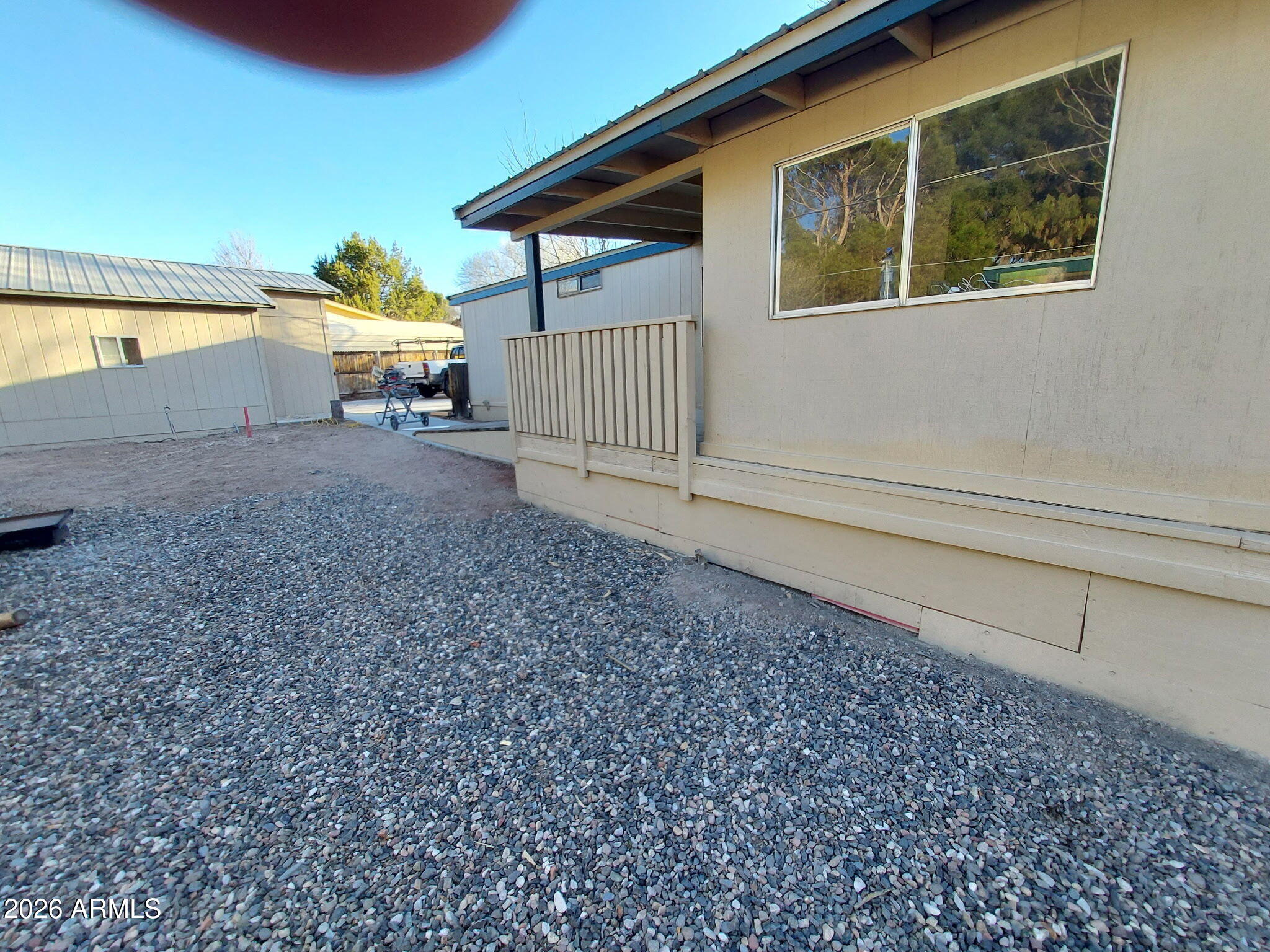 REDUCED FOR QUICK SALE, CASH ONLY! Updated single-wide manufactured home sits on a large lot and features 3 bedrooms and 2 full baths. Main home square footage is 980 per tax records, PLUS a spacious ARIZONA ROOM. There is a detached two-car garage with a small workshop area, along with two small sheds in the backyard. The spacious living room has a full flagstone hearth with a wood-burning stove. It includes a dishwasher, a new range hood, a washer and dryer, and a furnace. NEW hot water heater. The property has new propane service with a one-year transferable contract with Verde Valley Propane, powering the furnace, dryer, and kitchen stove. NO HOA. Perimeter fenced with front and back gates. All structures have metal roofs. The septic system was inspected and certified in January 2026. The property has been extensively upgraded, including new skirting and perimeter insulation, new access doors, fresh exterior paint, new beams and leveling under the structure. The interior features new flooring, trim, and paint throughout. The bathrooms have new toilets, sinks, and vanities. All lighting and hardware are new. A fully enclosed back porch has new carpeting, while the front enclosed porch has a fresh concrete paint finish matching the back carpeting. Enjoy a relaxed lifestyle in Camp Verde!