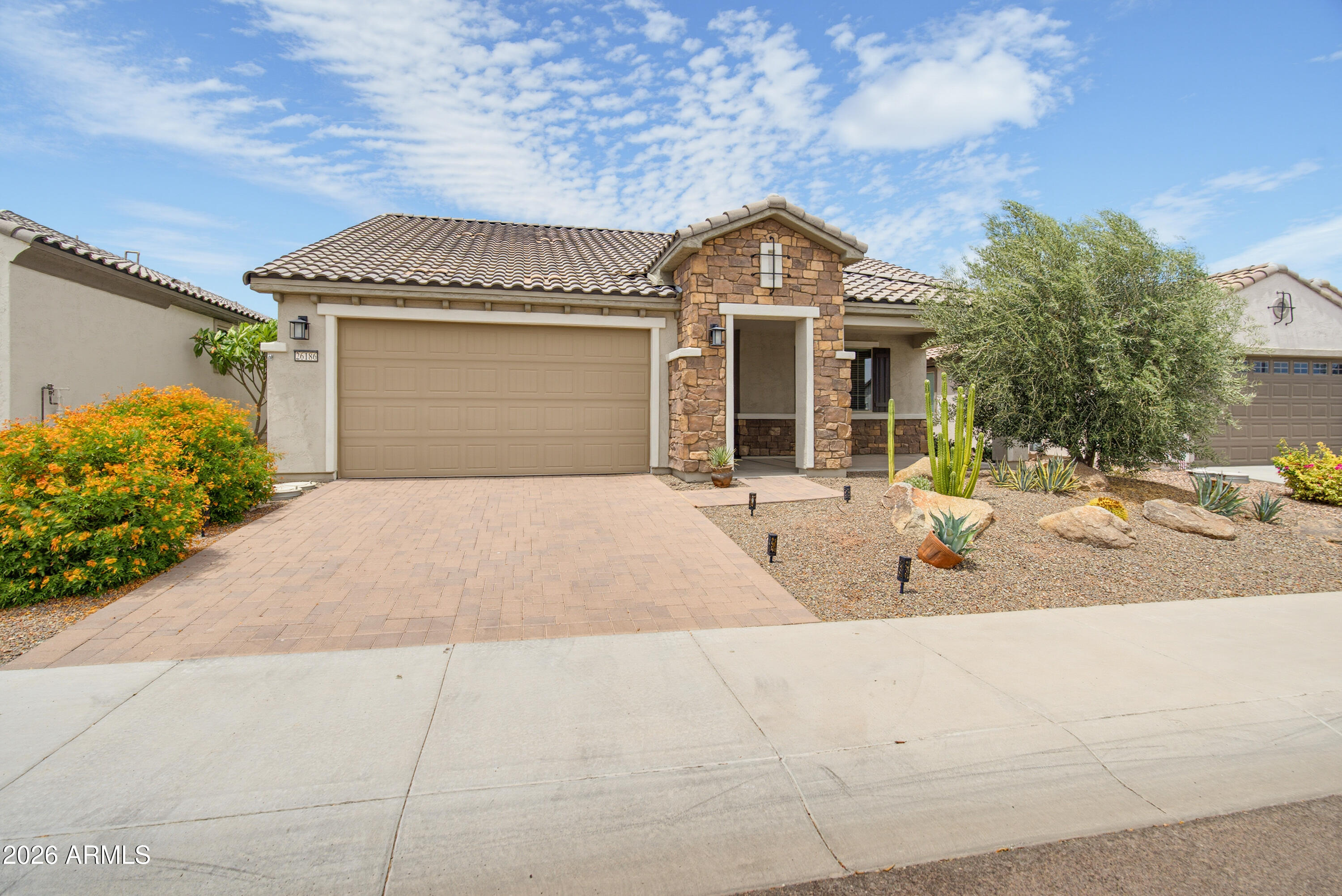 Move-in ready Hideaway model on a private walled lot featuring a rare 4' extended garage. This open-concept floor plan offers a seamless blend of comfort & style with abundant natural light, a custom media wall & spacious living areas. The upgraded kitchen showcases white cabinetry, quartz countertops, designer tile backsplash, pendant lighting & a large island perfect for entertaining. The extended primary suite features a tiled walk-in shower, dual sinks, vanity area & oversized walk-in closet. The guest bedroom & adjacent bath provide ideal accommodations for visitors. Enjoy the covered patio, low-maintenance landscaping & scenic mountain views. Ideally located just steps from exceptional community amenities.