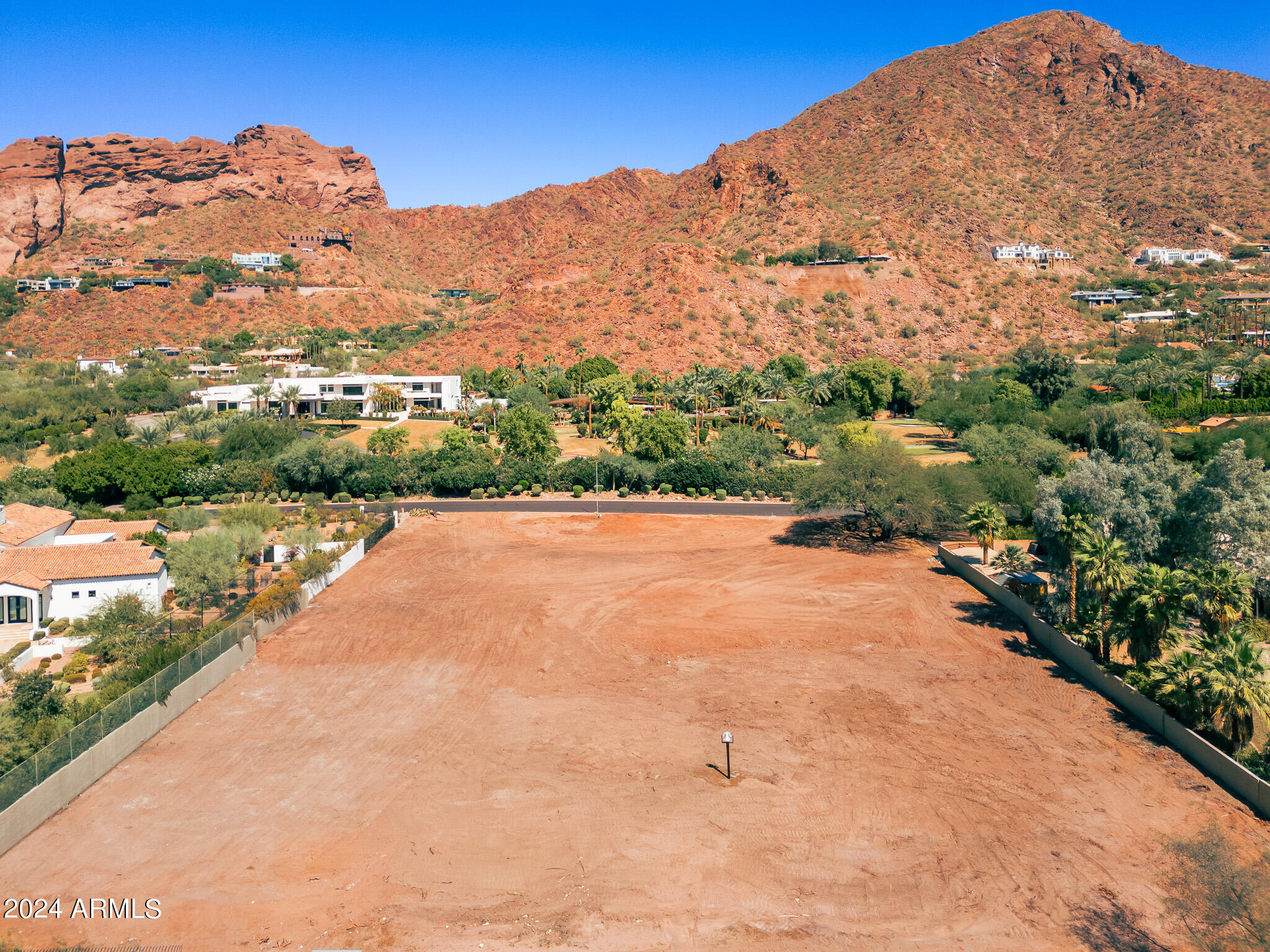 One of the final opportunities to own over 1.4 acres in White Gates, Arcadia's most prestigious enclave, known for its expansive lots, stunning mountain vistas, and underground power lines. This prime, flat, and rectangular lot offers panoramic views of Camelback Mountain, making it the perfect canvas for your dream estate. Additionally, it is located within the highly sought-after school district that includes Hopi Elementary, Ingleside Middle, and Arcadia High. Don't miss out on this exceptional property! Full set of plans and designer look book available if buyer is interested.