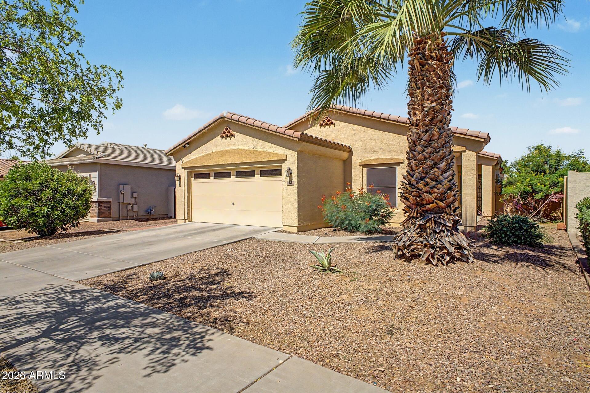 **REDUCED** Welcome home to this charming 3-bed, 2-bath home that has been lovingly maintained and is truly move-in ready. Featuring durable vinyl plank and tile flooring throughout, this home offers both style and easy maintenance. Utilize the den as office space, or create a fourth bedroom.  The open kitchen and dining area create the perfect space for everyday living and entertaining, all while overlooking the lush green grass backyard view. The home has a split floor plan for privacy with the primary suite towards the back of the home. Additional highlights include: overhead garage storage, newer garage door motor (with camera), newer water heater with warranty, newer ash trees and irrigation in backyard.  Walkable community - Starbucks, AMC theaters, restaurants and gyms nearby
